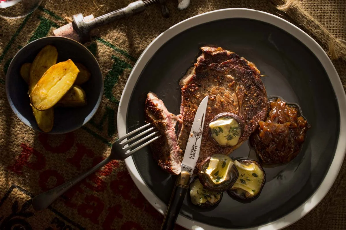 Grilled rib eye stake with brie filled mushrooms, onion jam and pan seared kipfeler potatoes