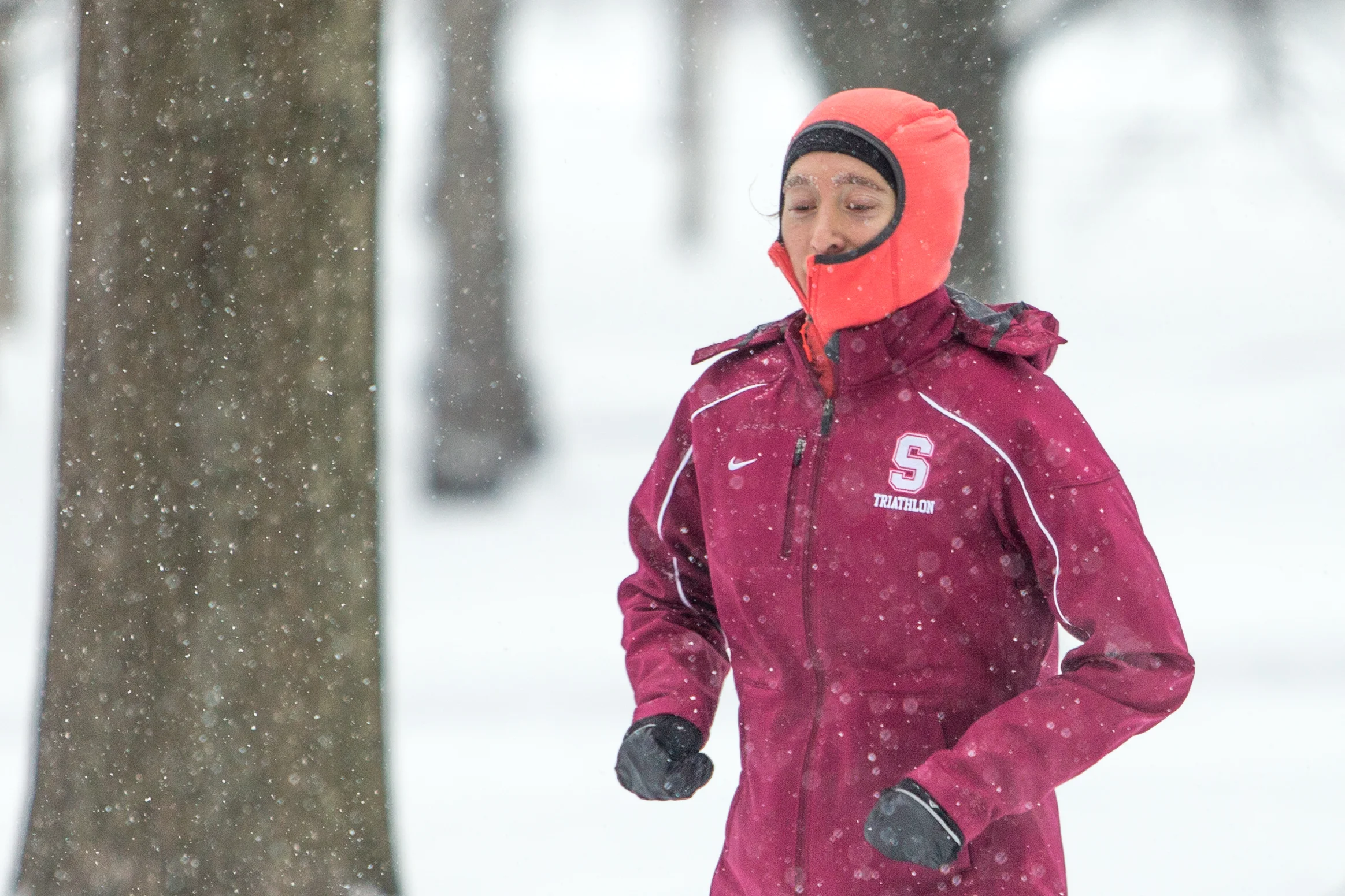 A runner makes their way along the Charles River in Cambridge during a heavy snow on Dec. 17, 2016.