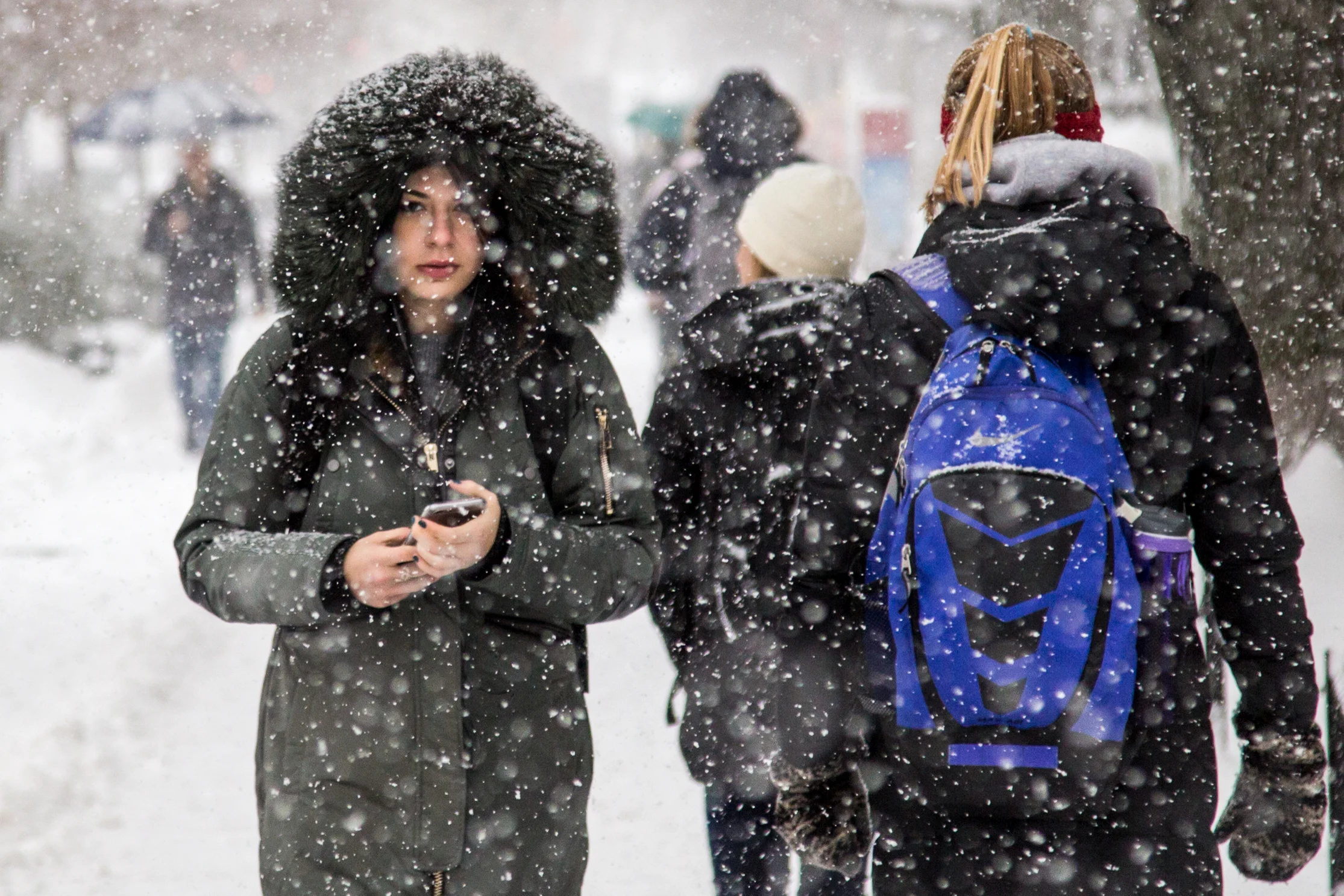 Students walk through heavy snow on Commonwealth Ave., in Boston, Dec. 17, 2016 during the first heavy snow of the season. 