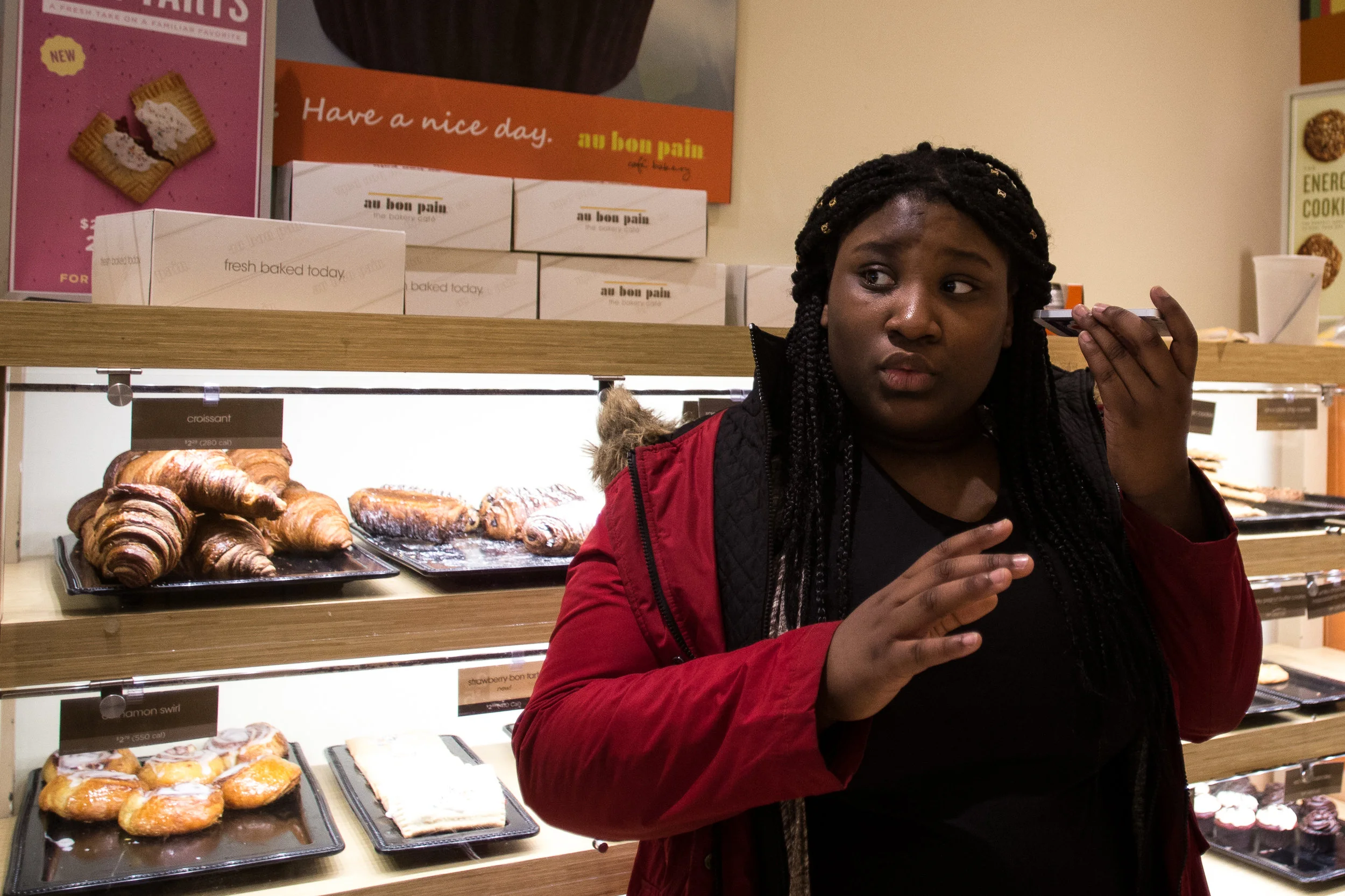 Pierresaint speaks to her mother on the phone during a lunch break in between bouts of Louder Than a Bomb April 8 in Boston. Andrine speaks Haitian Creole fluently and now helps her grandmother learn English.