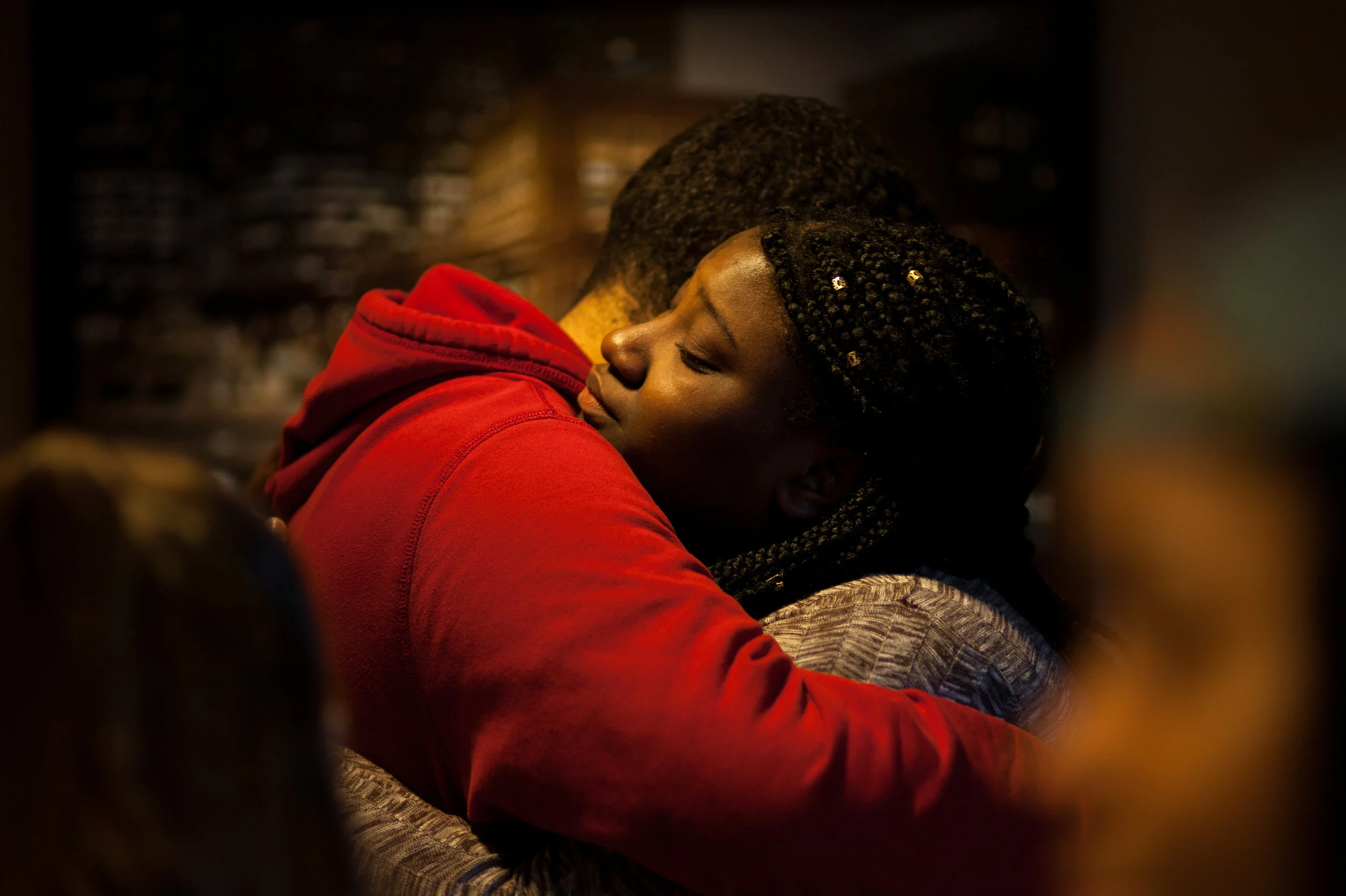 A teammate hugs Pierresaint after she performed a poem that made her emotional during Louder Than A Bomb preliminaries April 8 in Boston. 