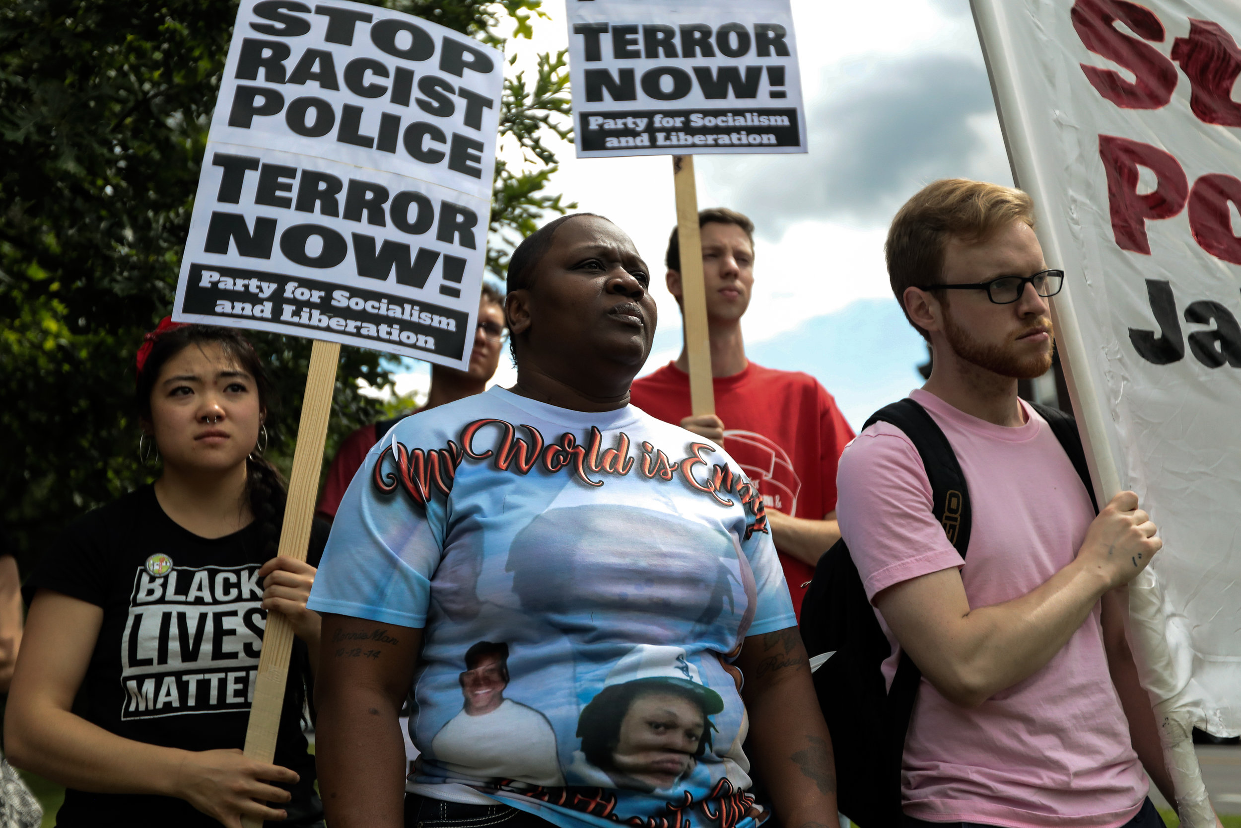 Dorothy Holmes, center left, the mother of Ronald Johnson, who was killed by a Chicago police officer in 2014, stands with other protesters before a march in Chicago on Sunday, June 18, 2017 to protest the acquittal of the police officer who killed Philando Castile. Holmes is starting a petition to have a portion of Washington Park renamed in honor of her son.
