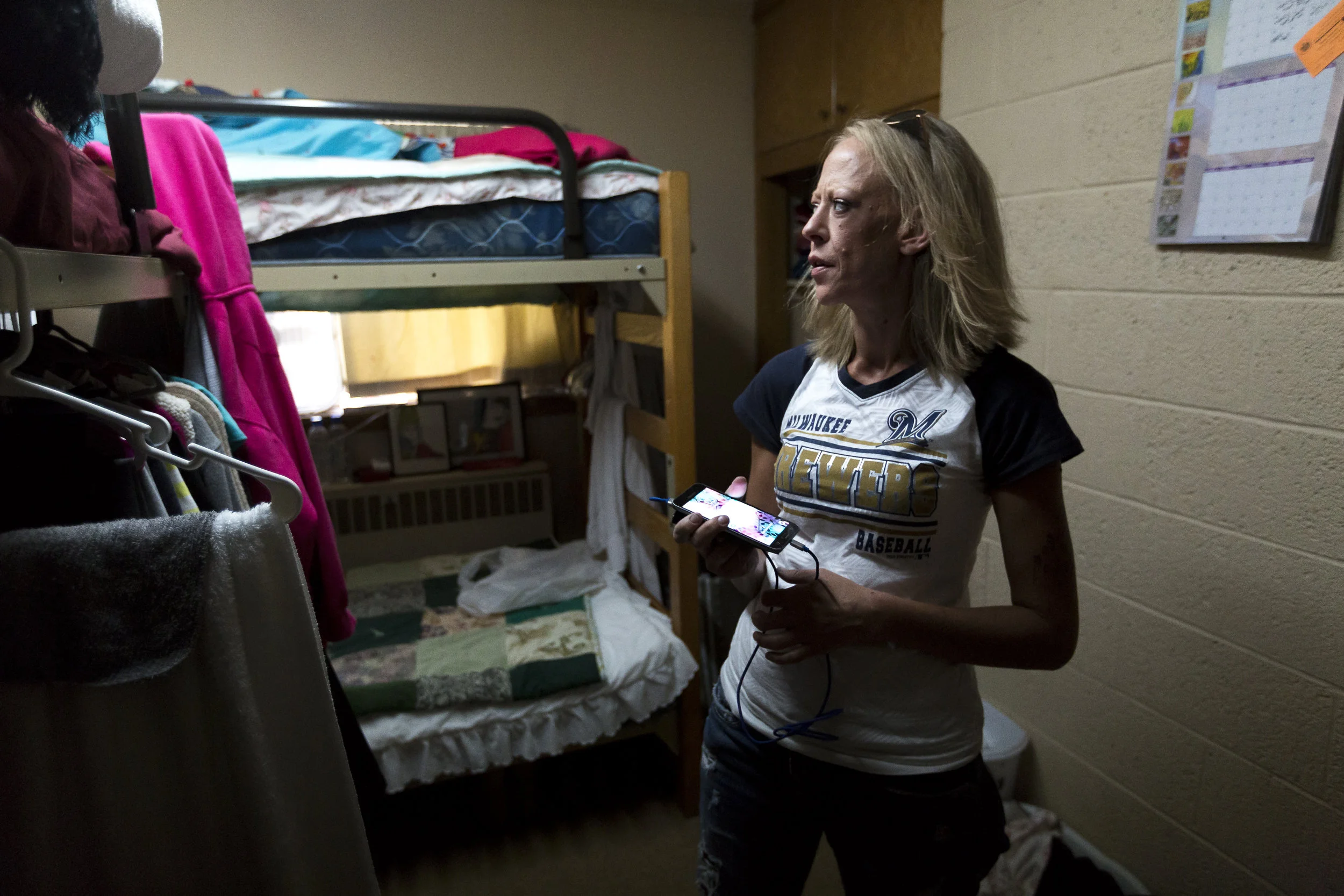 Solis stands in the room she shares with three other women in the Salvation Army.