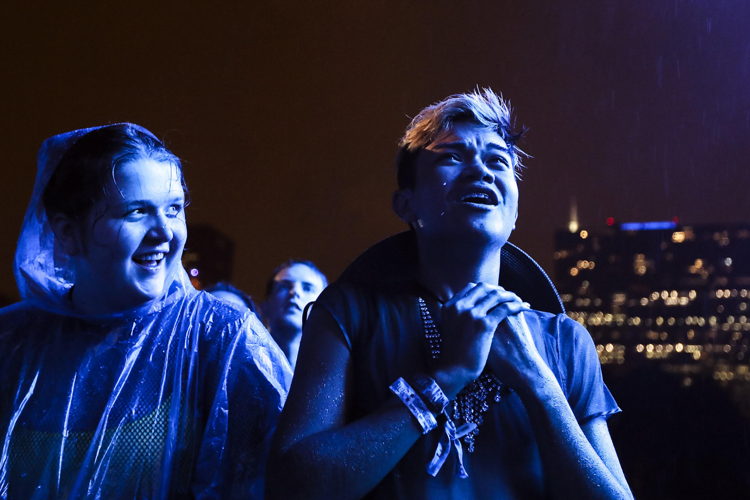 Ranvier Villamil reacts to Lorde's performance in heavy rain on the first day of Lollapalooza in Chicago's Grant Park on Thursday, August 3, 2017.