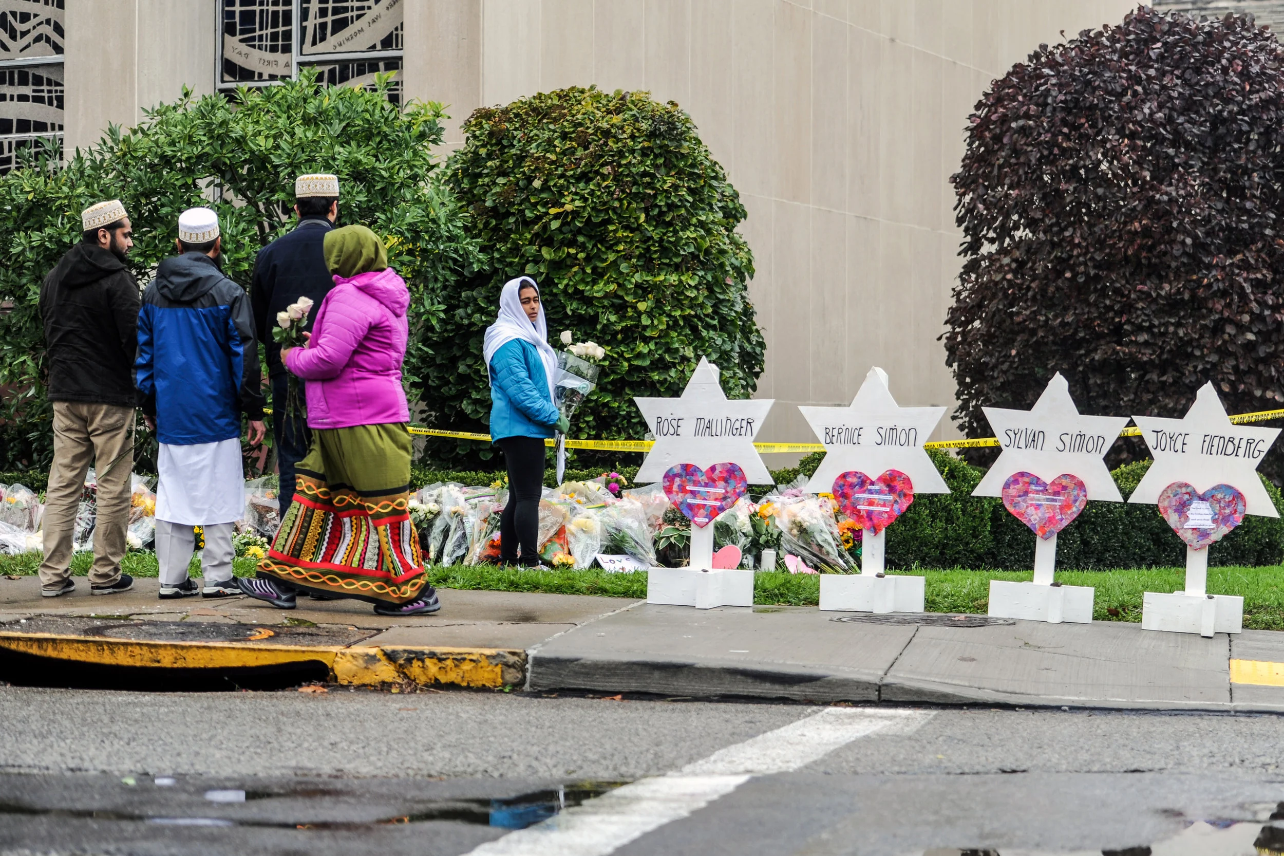 Members of Pittsburgh's Dawoodi Bohra Muslim community leave flowers at the memorial in front of the Tree of Life synagogue, Sunday, Oct. 28, 2018, in Squirrel Hill. ”This could have been our mosque. This could have been any congregation," said Kutub Ganiwalla, pictured second from left.