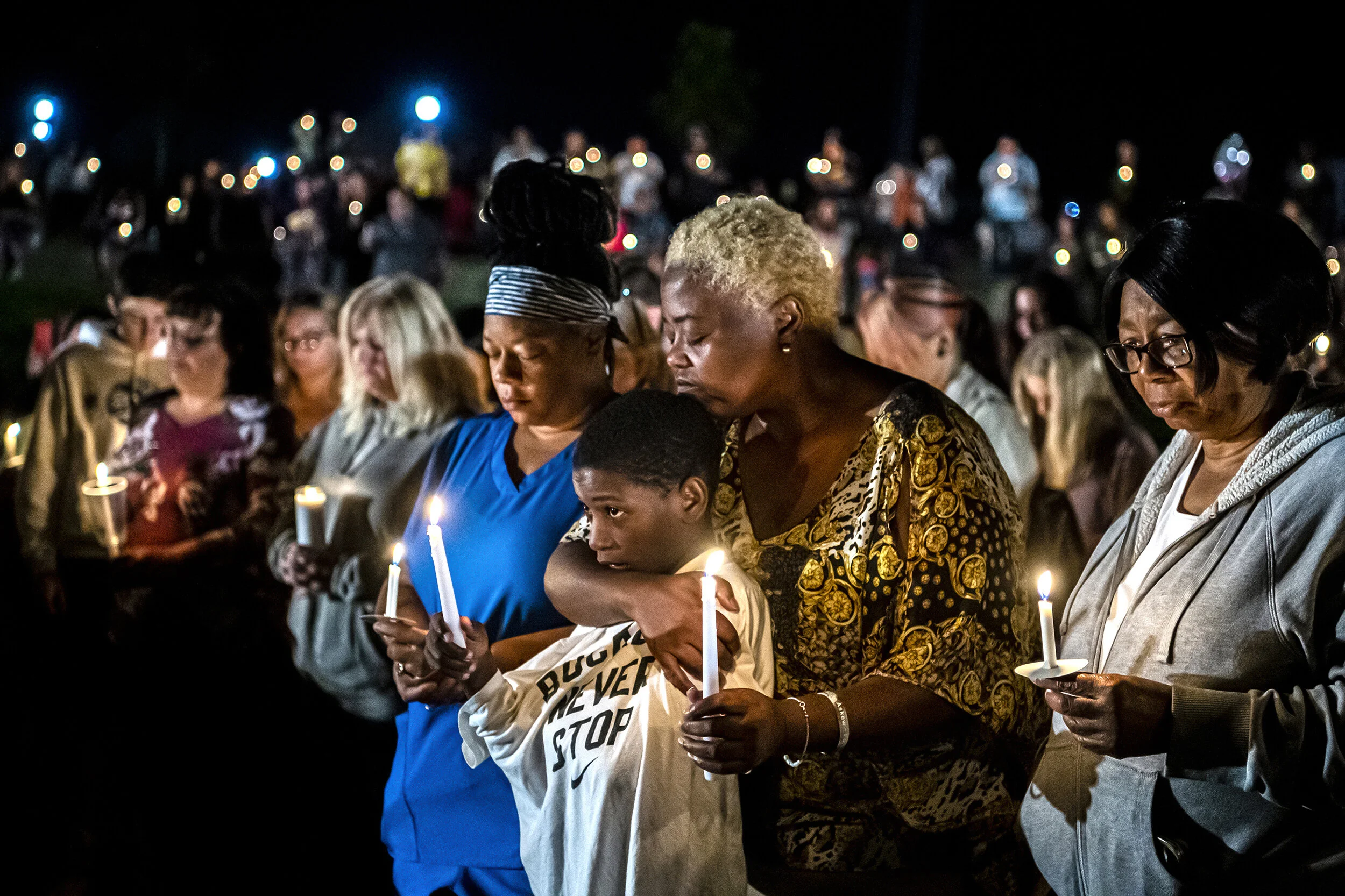  Marilyn McFarlin, second from right in the front, of Blairsville, Pa., embraces her son Vinnie, 9, as attendees pray during a vigil for Nalani Johnson, a toddler who was found dead still buckled in her car seat after being missing for nearly three d