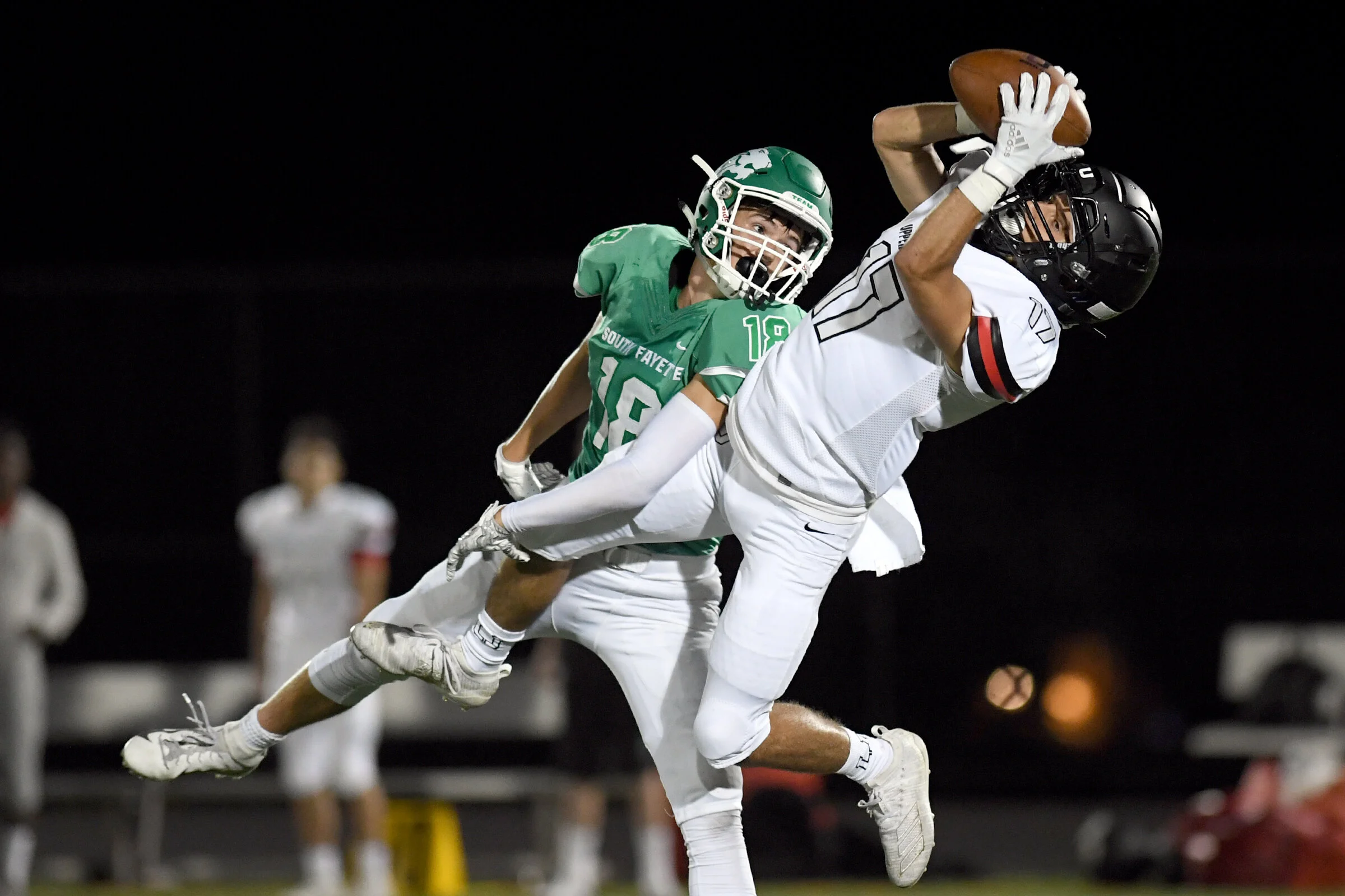  South Fayette's Ryan McGuire (18) tackles Upper St. Clair's Ben Lund (17) as he catches a pass during the season opener game between Upper St. Clair and South Fayette at South Fayette High School, Friday, Aug. 23, 2019, in South Fayette, Pa. 