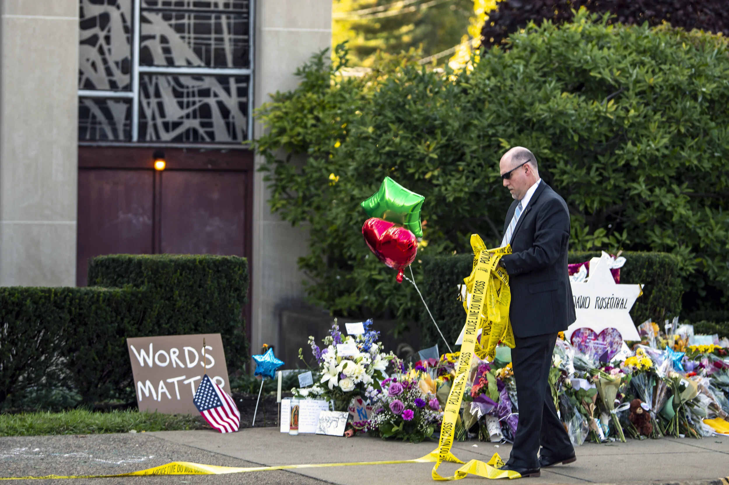  An official removes caution tape from a memorial in front of the Tree of Life synagogue prior to the arrival of President Donald Trump, Tuesday, Oct. 30, 2018, in Squirrel Hill. 