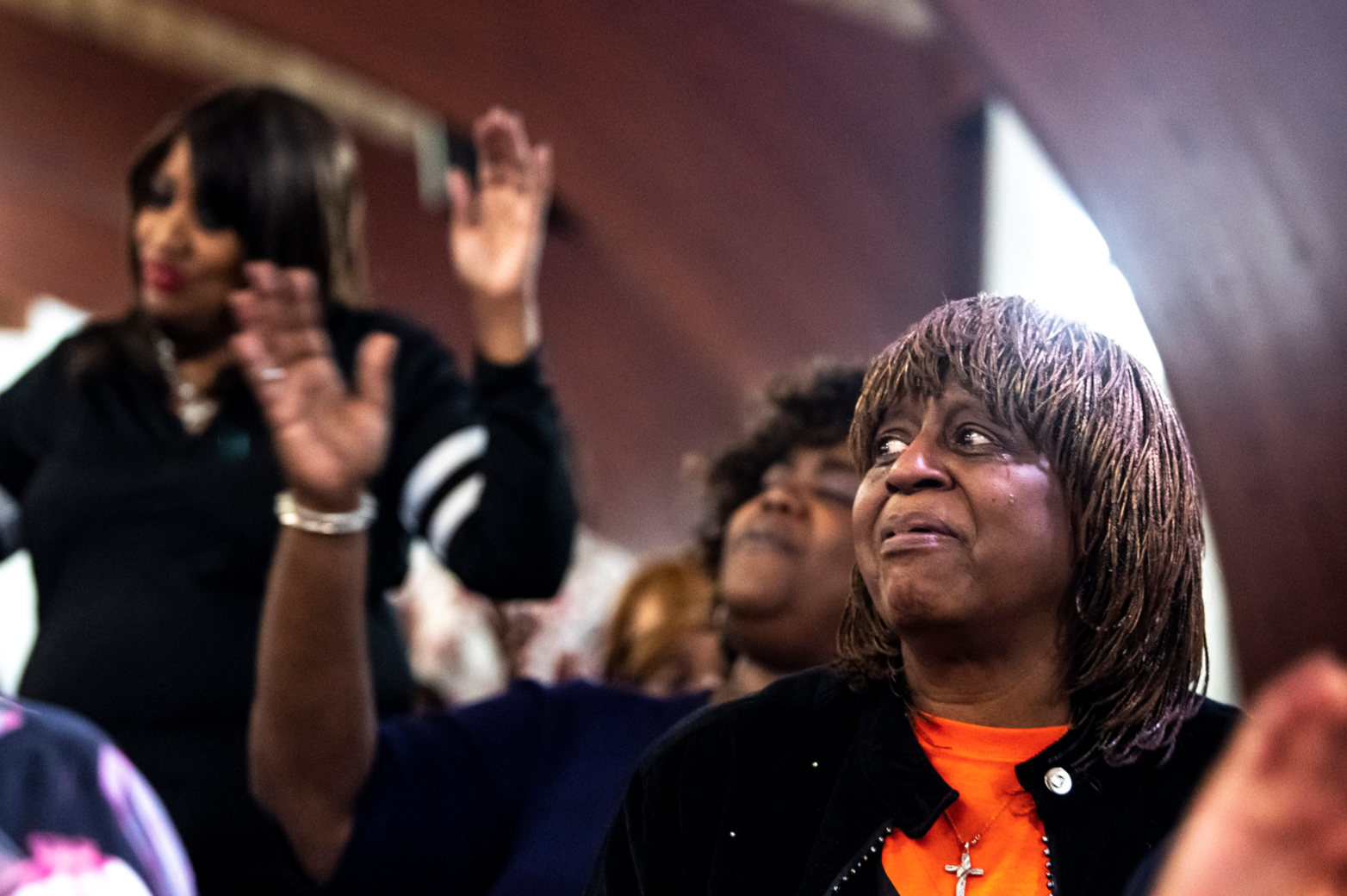  BJ Samson, right, of East Liberty, cries while listening to the Rodman Street Choir during a joint prayer service held by the East End Baptist Fellowship and Homewood Community Ministries to show solidarity with the Jewish community, at Rodman Stree