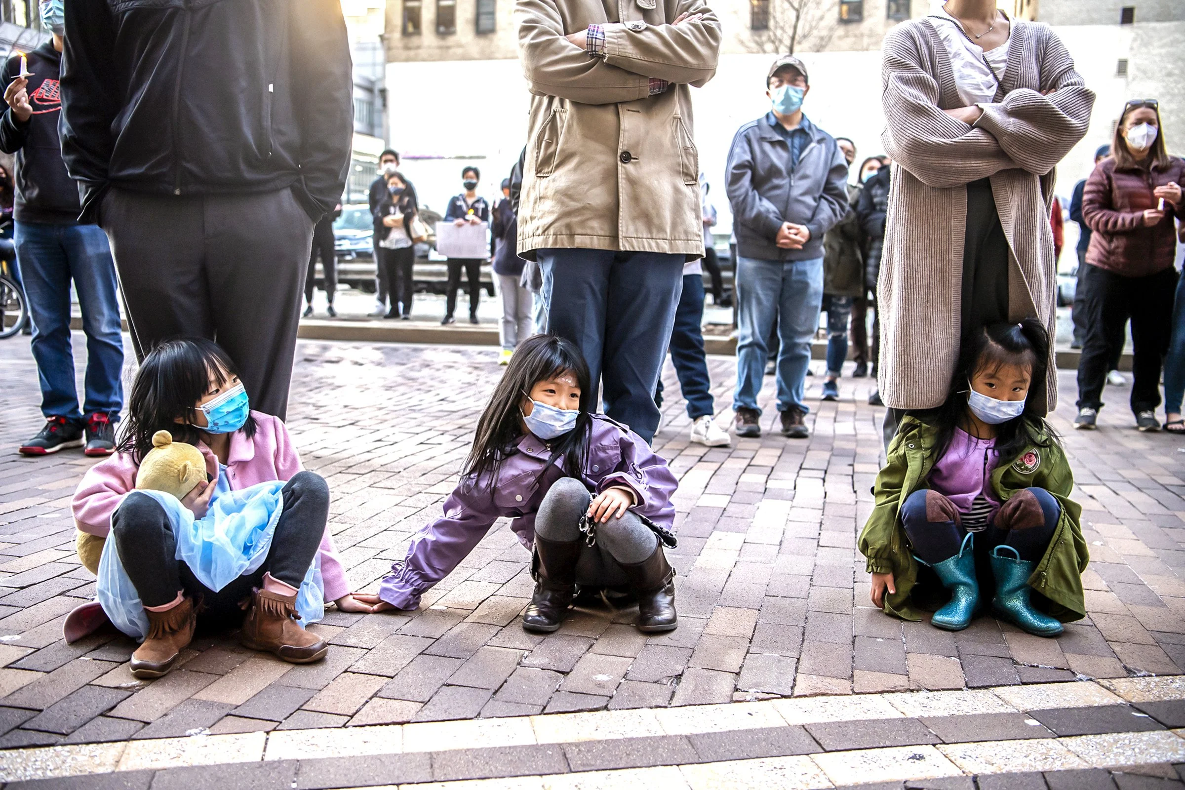  From left sitting, Angela Lin, 6, Vickie Xu, 6, and Selina Xu, 4, sit at the feet of their parents, from left standing, Hang Lin, Jinquan Xu, and Xuejiao Sun, all of the Shadyside neighborhood of Pittsburgh, as they listen to a speaker during a cand