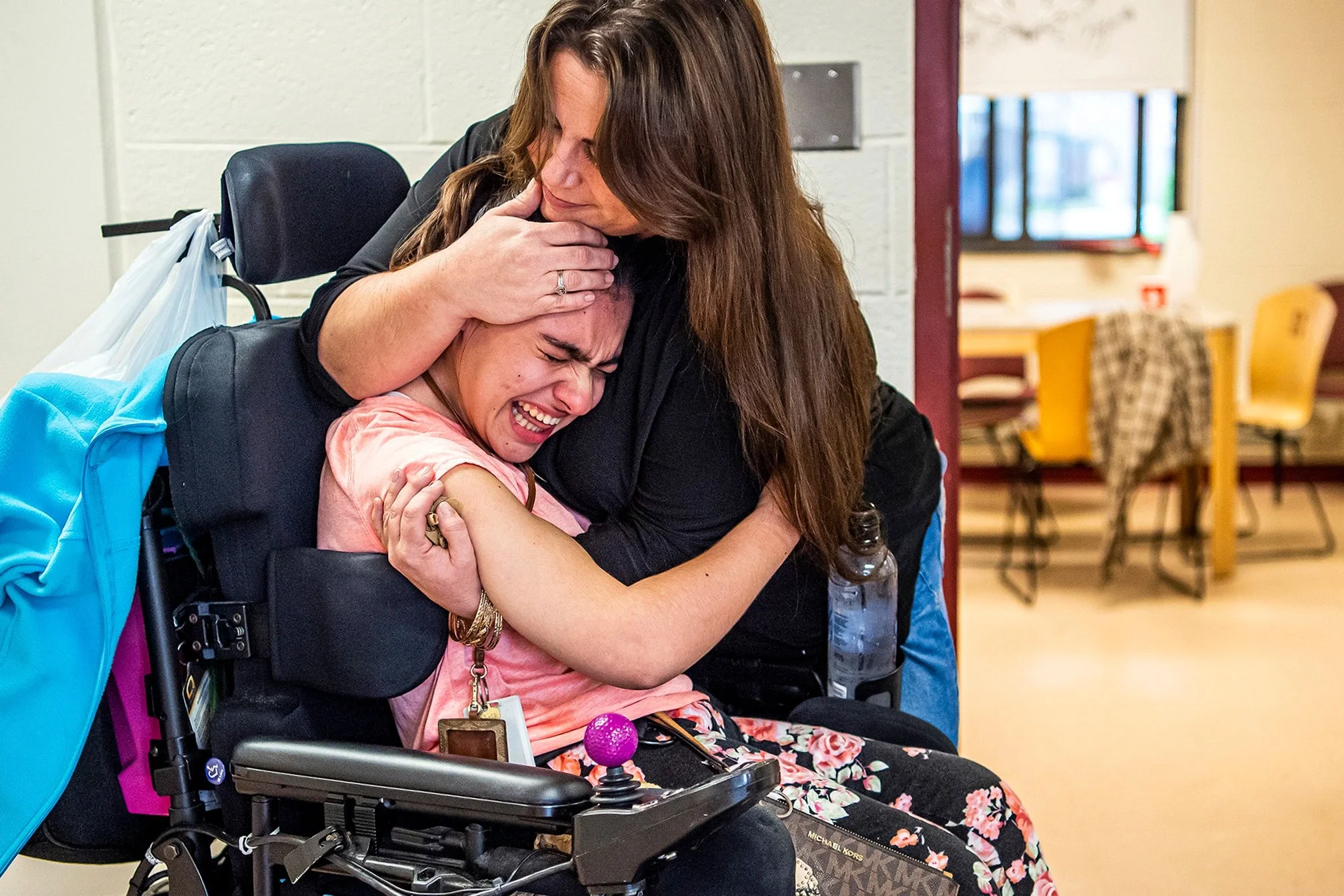  Veronica Siaba, of Queens, N.Y., sobs as she's comforted by Shelly Ferritto, of Erie, Pa., a nurse aide whose job was eliminated with the attendant care program, as Ms. Siaba prepares to leave with her family after moving out of her dorm room, Frida