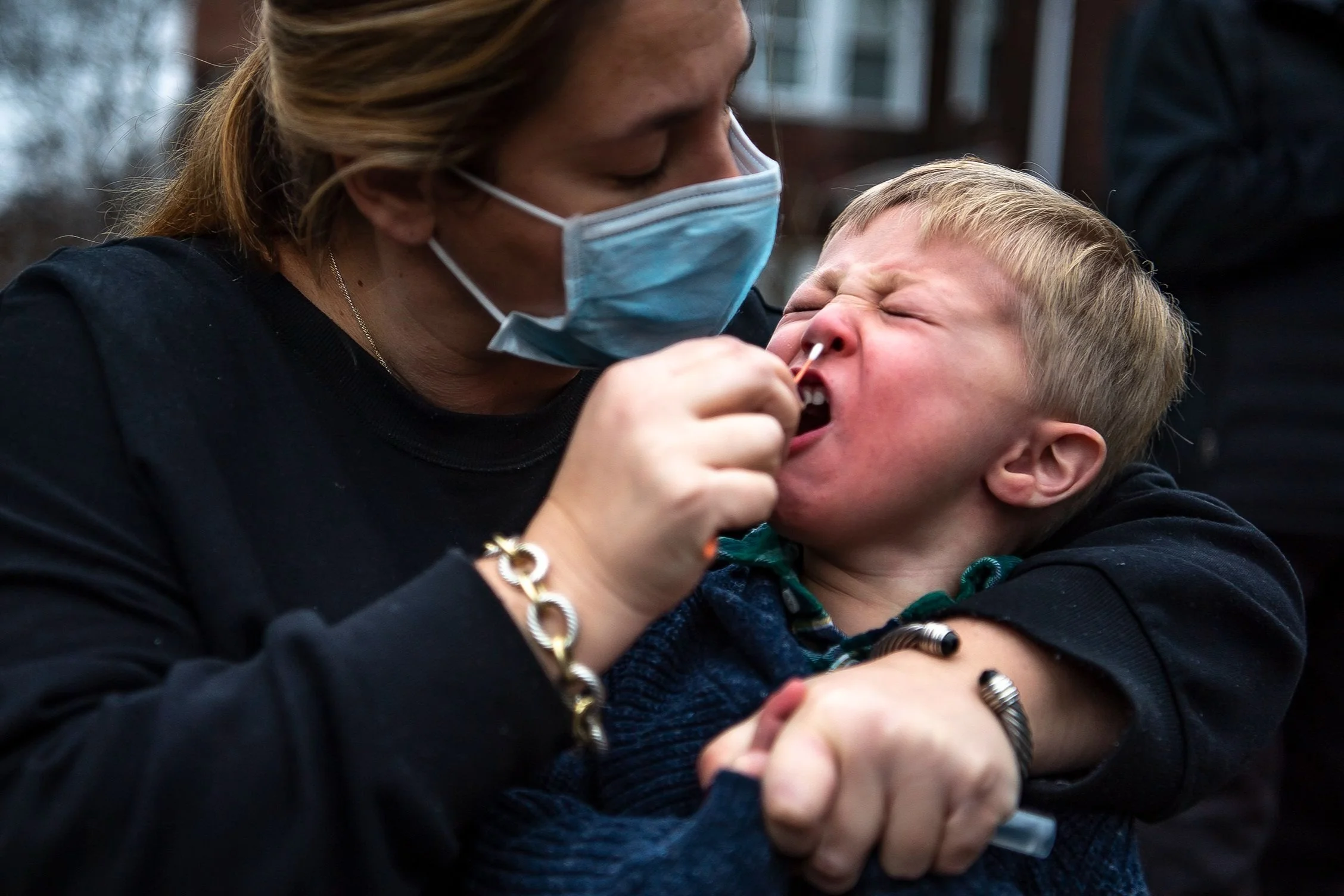  Sarah Glick, of the Squirrel Hill neighborhood of Pittsburgh, helps her son Harrison, 3, swab his nose while getting tested for COVID-19 at the Curative testing van parked off Wightman Street in Squirrel Hill, Tuesday, Dec. 28, 2021. Glick said they