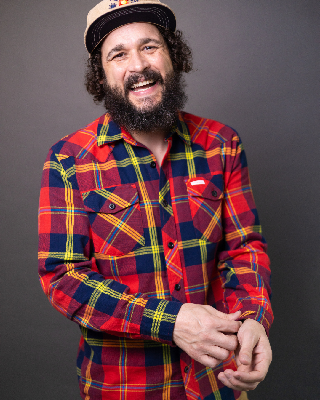 aj finney in flannel shirt laughing