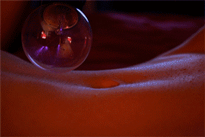 This is a violet wand. It produces sensations varying from electrified tingles to biting shocks depending on what attachments are used and how they are implemented. Using a violet wand with rope woven with mylar, which is conductive, would send electric tingles anywhere the rope was touching skin. This is not an activity for kink newbies, and should only be practiced with Risk Aware Kinksters.
