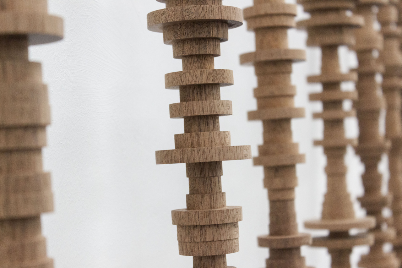 HK-MK, 21 mahogany poles, book, 230 x 500 x 20 cm, 2015 (detail)