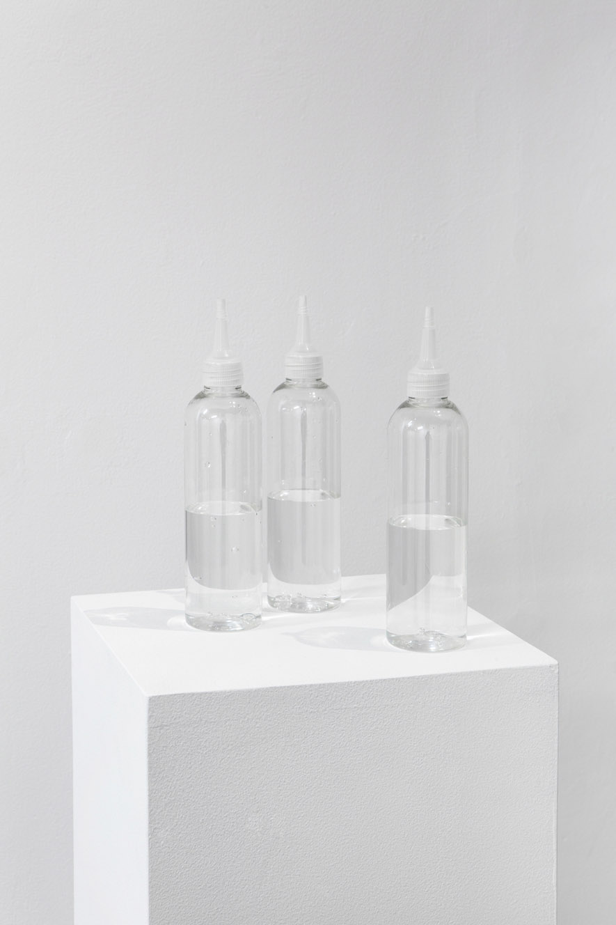 22.01.16 (detail): 3 bottles half empty/half full on pedestal. 300 bottles on ice cubes, to consume. Gin, tonic, vodka, Get 31, sparkling water, variable dimensions. Courtesy Ben Elliot & ARTAGŌN