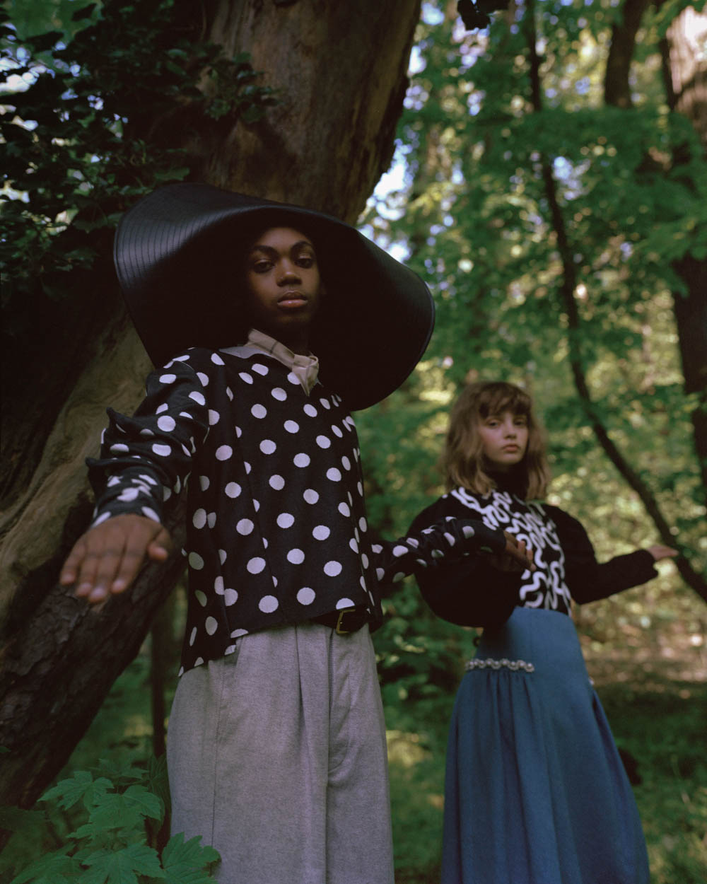 Jamil wears hat J.W. ANDERSON top SHIORI SUZUKI pants KING & TUCKFIELD scarf ARE YOU . Maja wears top J.W. ANDERSON skirt MOTHER OF PEARL