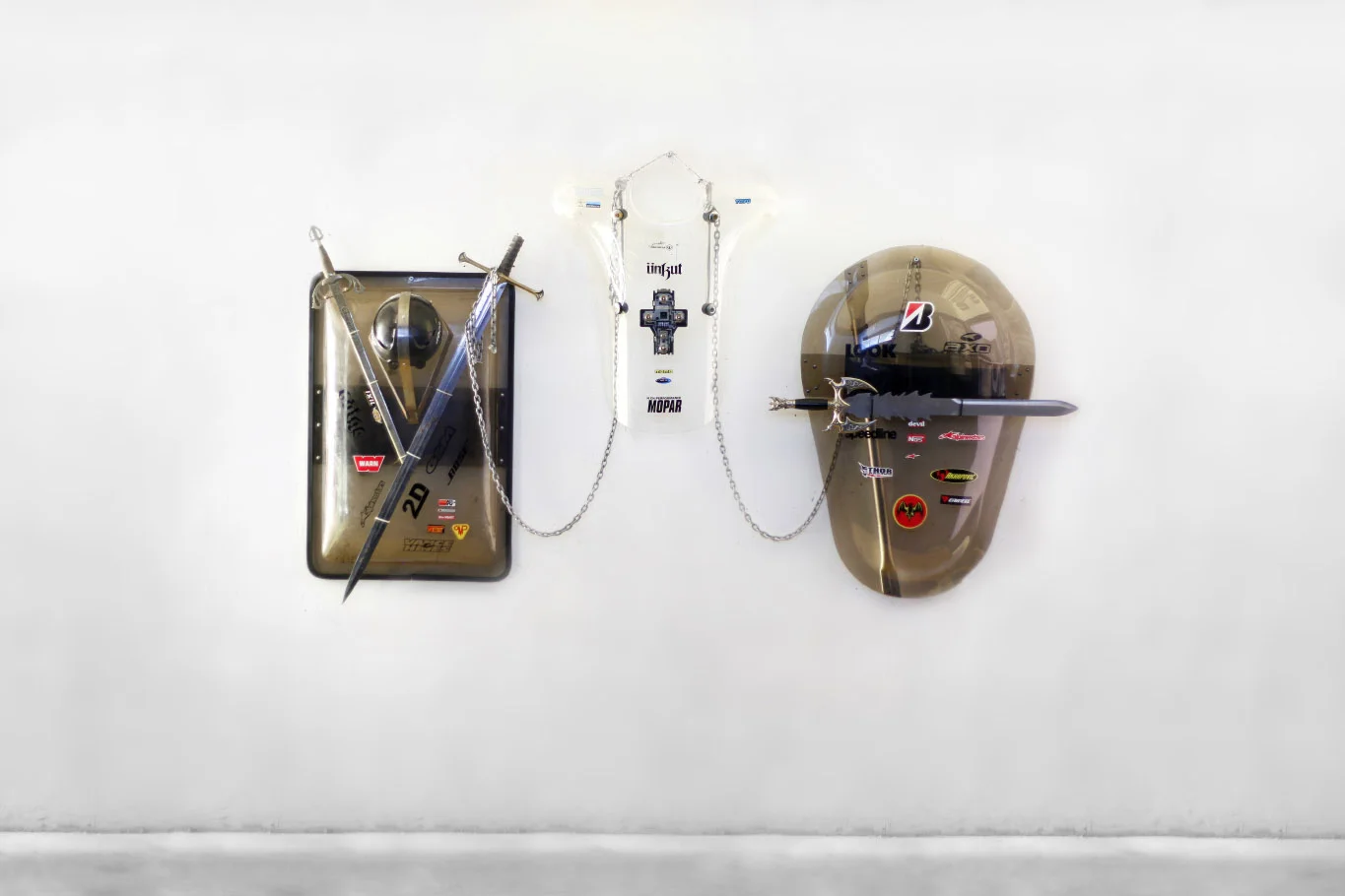 Armoirie, 2017. CRS police shields, visor of Vespa, swords, chains & stickers. Variable dimensions. Studio view - la Sira, Asnières.