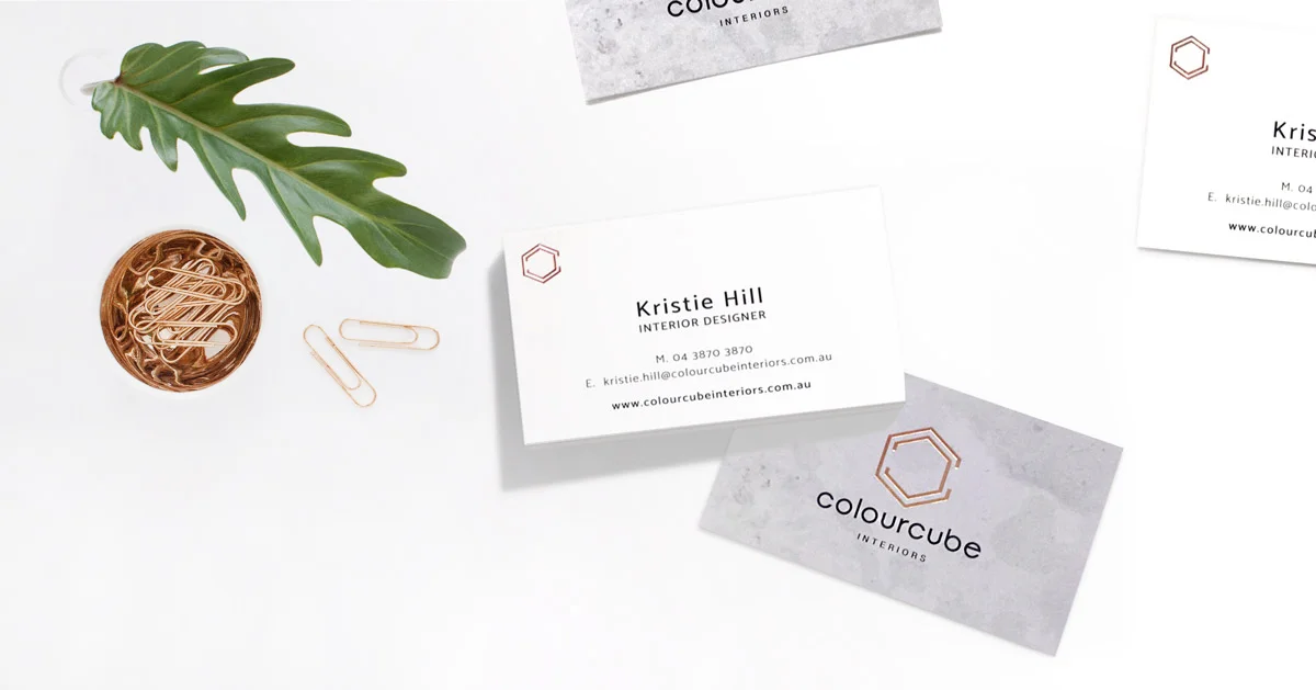 ColourCube Interiors business cards with concrete textures and rose-gold foil finish.