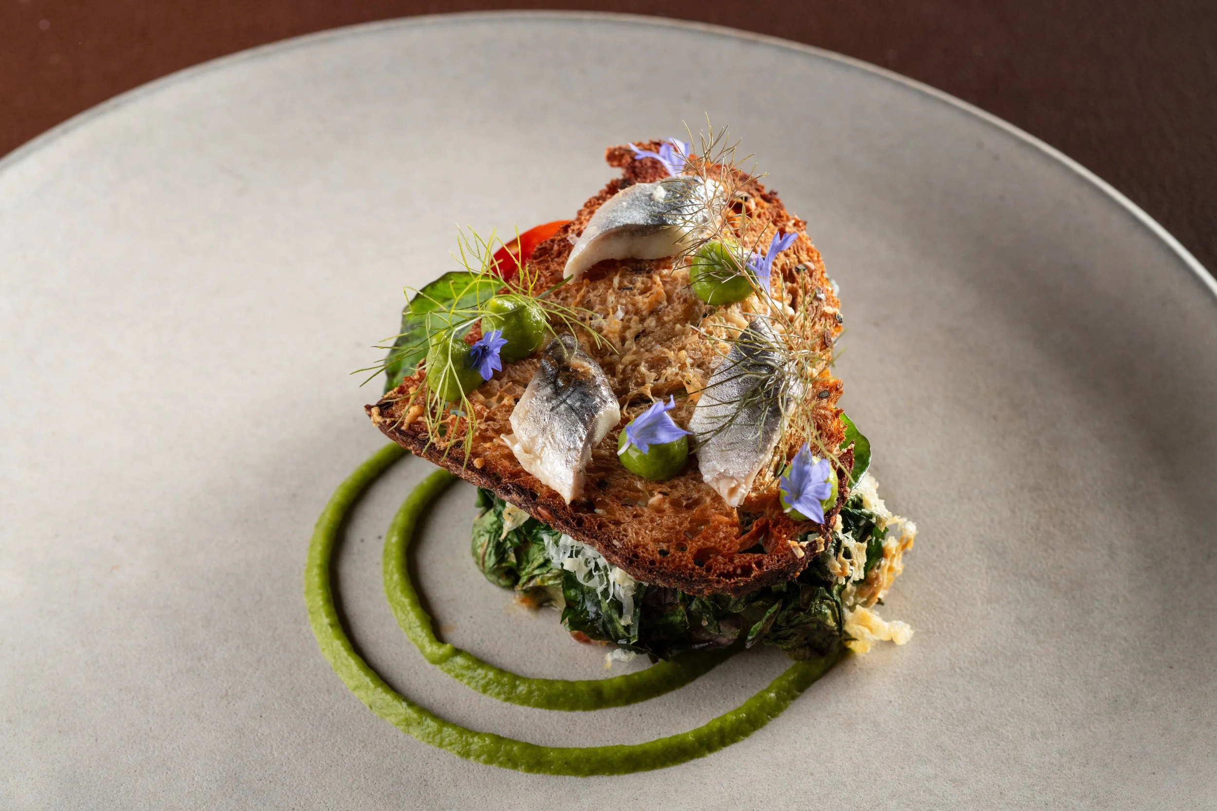 Lamb saddle, garnished with toast and decorative flowers, available at Sepia in Chicago's West Loop, tasting menu 