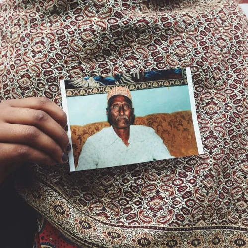Fatiima with a picture of her grandfather.