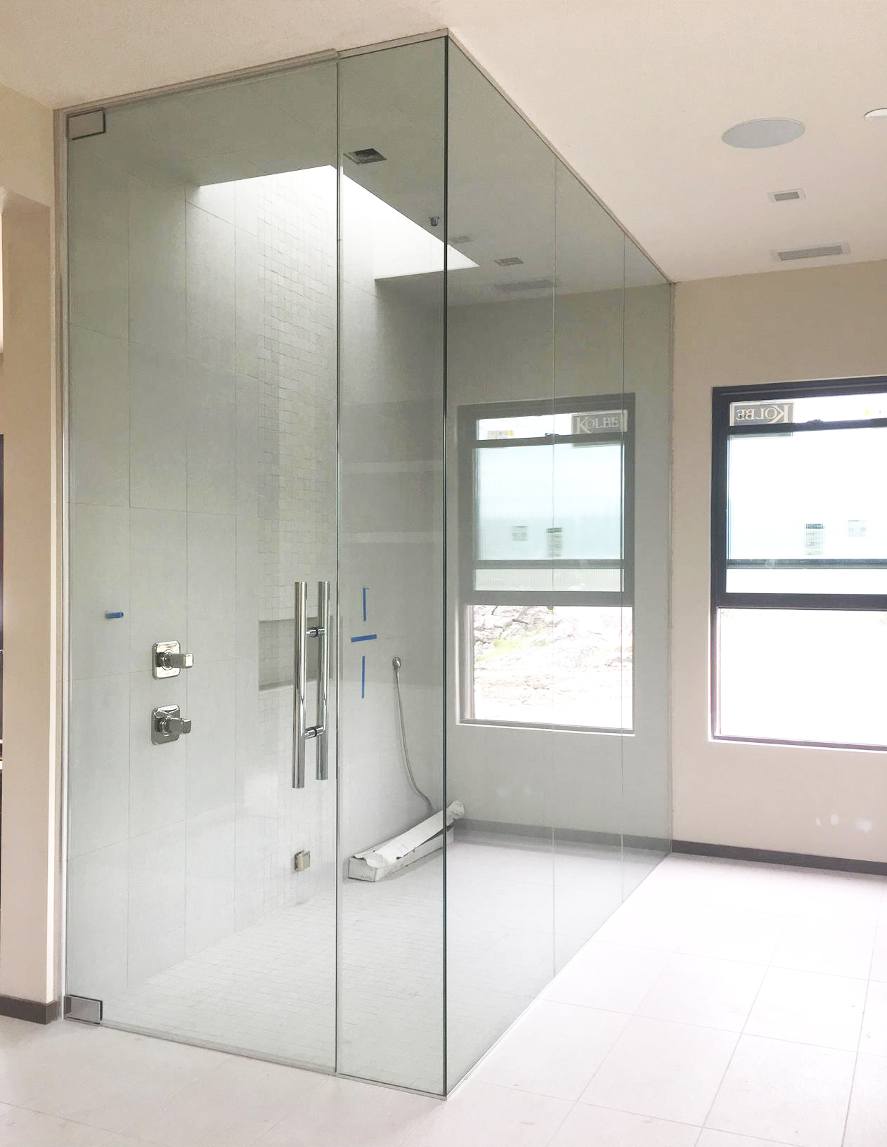 Standard clear Regency series enclosure with channel, pivot hinges, and three in-line return panels. 