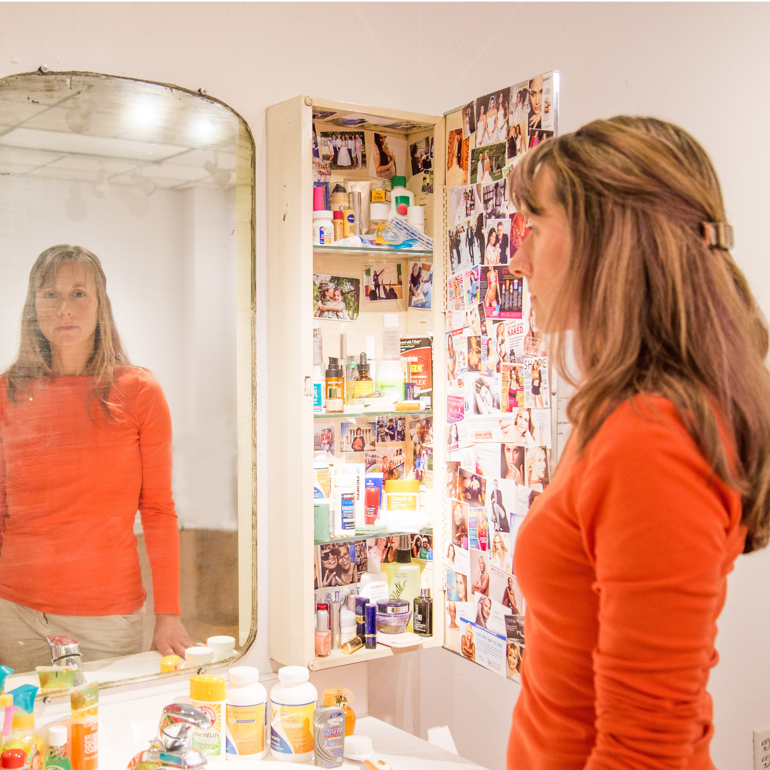 Kristen standing in front of her installation, Life in the cabinet (timeline of a woman's life), 2 016, part of the SHE Project - Part I. 