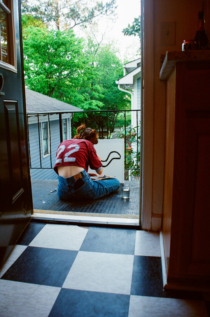 Grace painting outside her apartment, April 2021