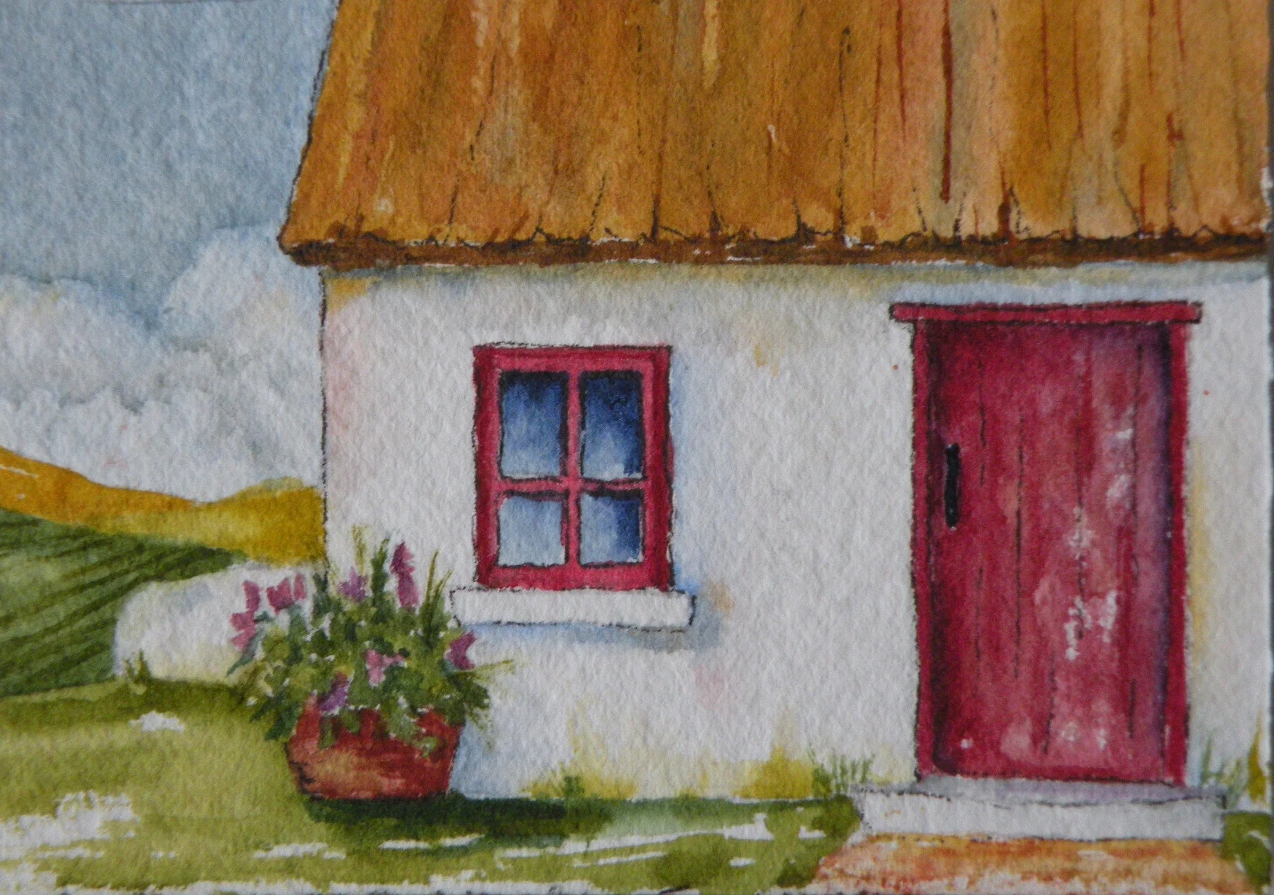 An Irish cottage of old with a red door.  Just beyond the cottage you can see the green fields of Ireland.