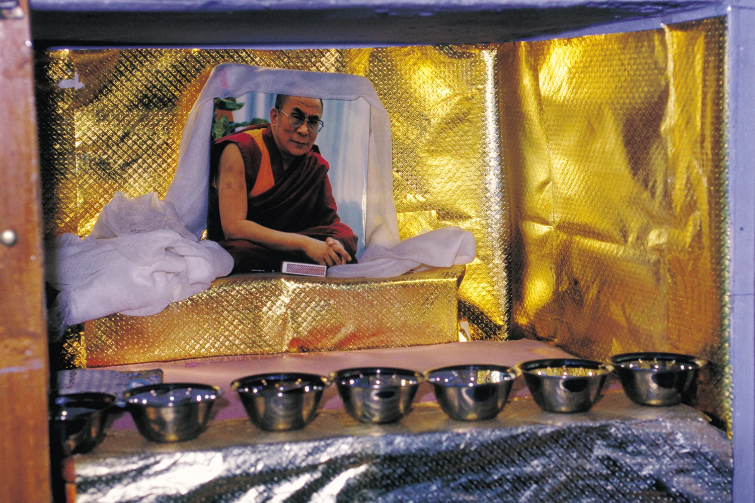 Each girl in the dormitory room has her own personal shelf space. This is Llama's altar with an image of the Dalai Lama, spiritual leader of Tibet.