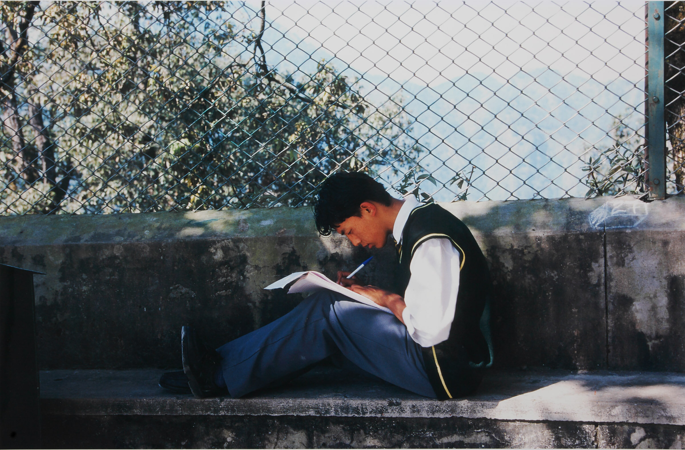   Barbara Goodbody, Boy in school courtyard taking exam, 1999, C print, 13 x 19”  