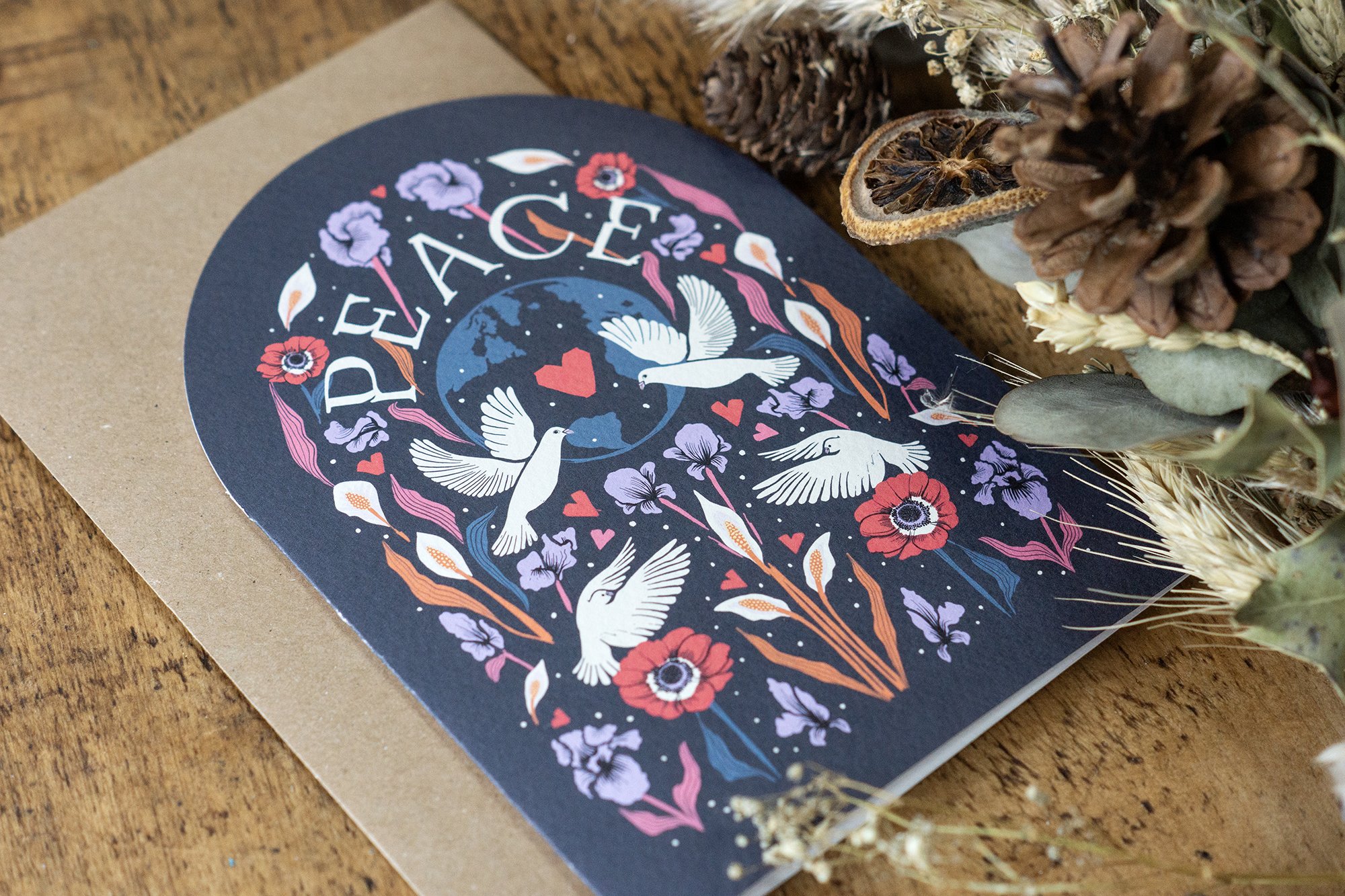  photograph of a beautifully illustrated Christmas card design with birds and flowers in vintage colours 