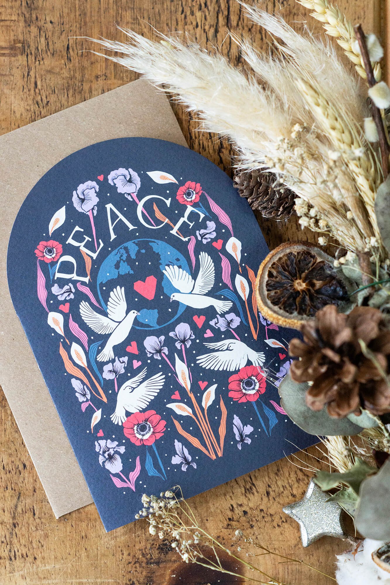 photograph of a beautifully illustrated Christmas card design with birds and flowers in vintage colours 