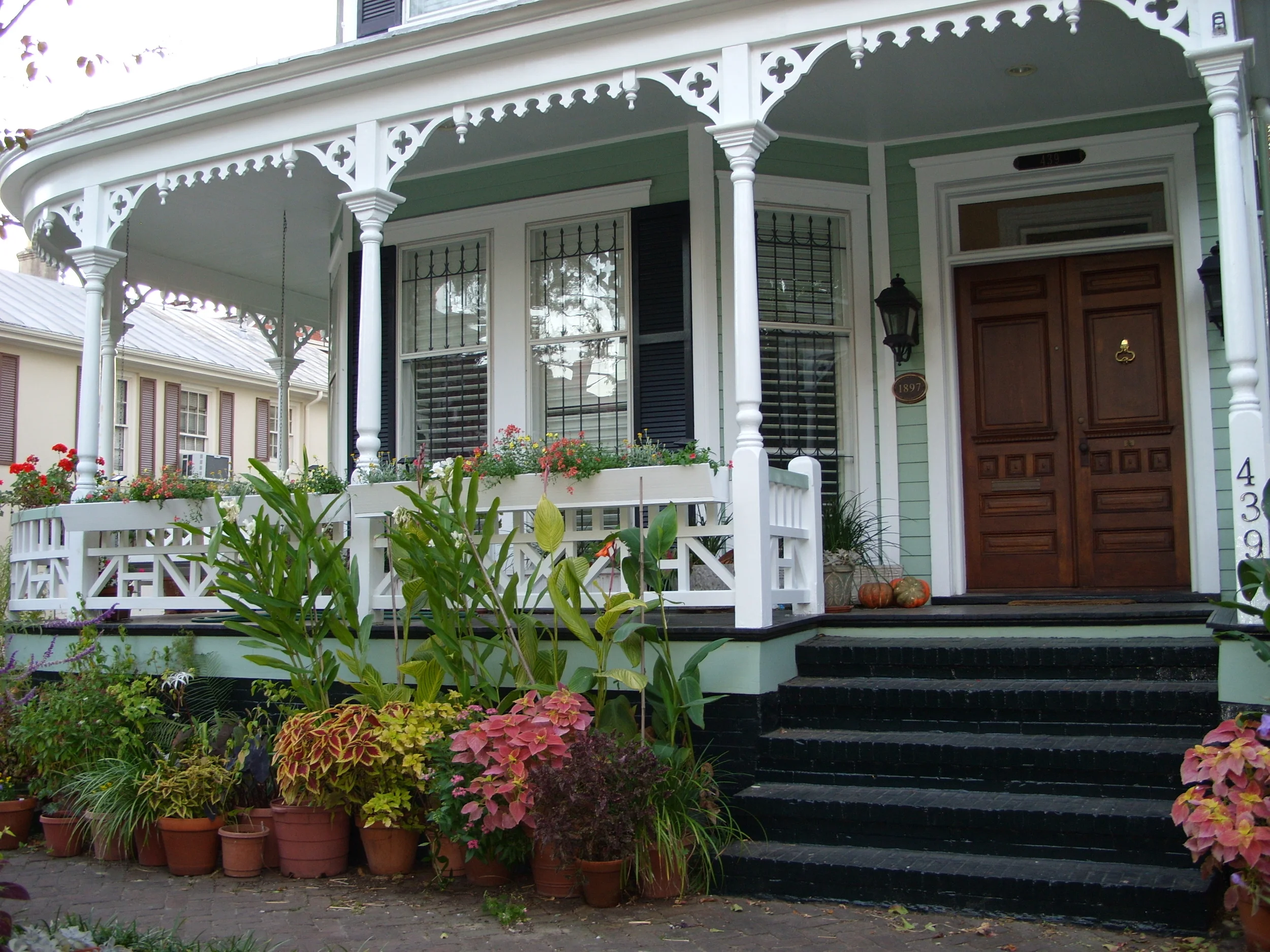  A Victorian house near Whitfield Square with flowers on the porch. 