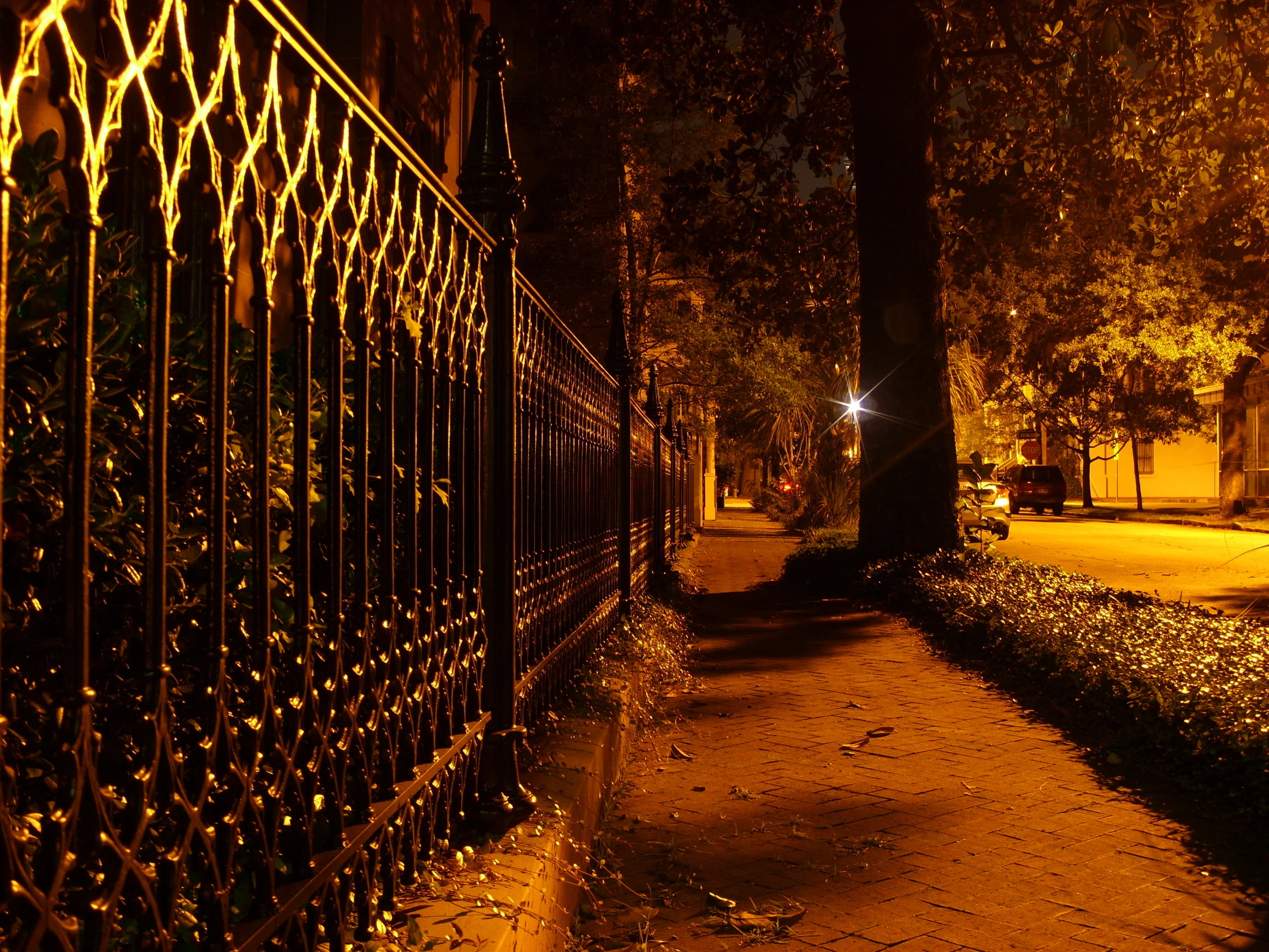  A nighttime shot looking down the fence of the Unitarian Universalist Church next to Troupe Square. 