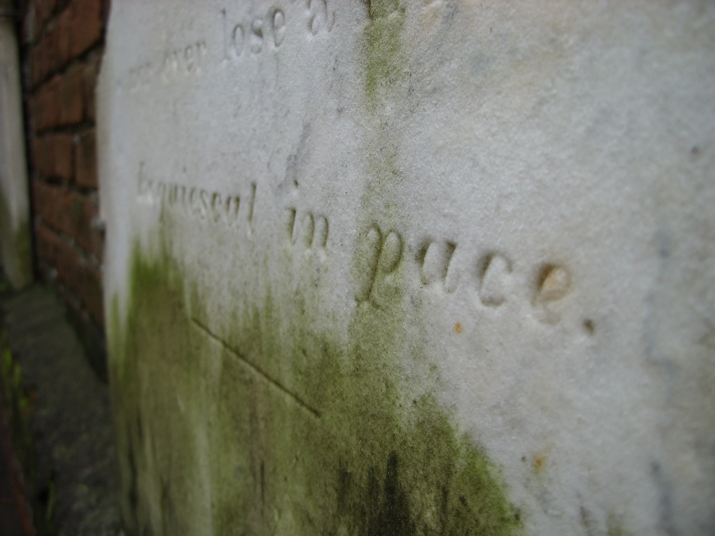  A tombstone against the east wall in Colonial Park Cemetery . 