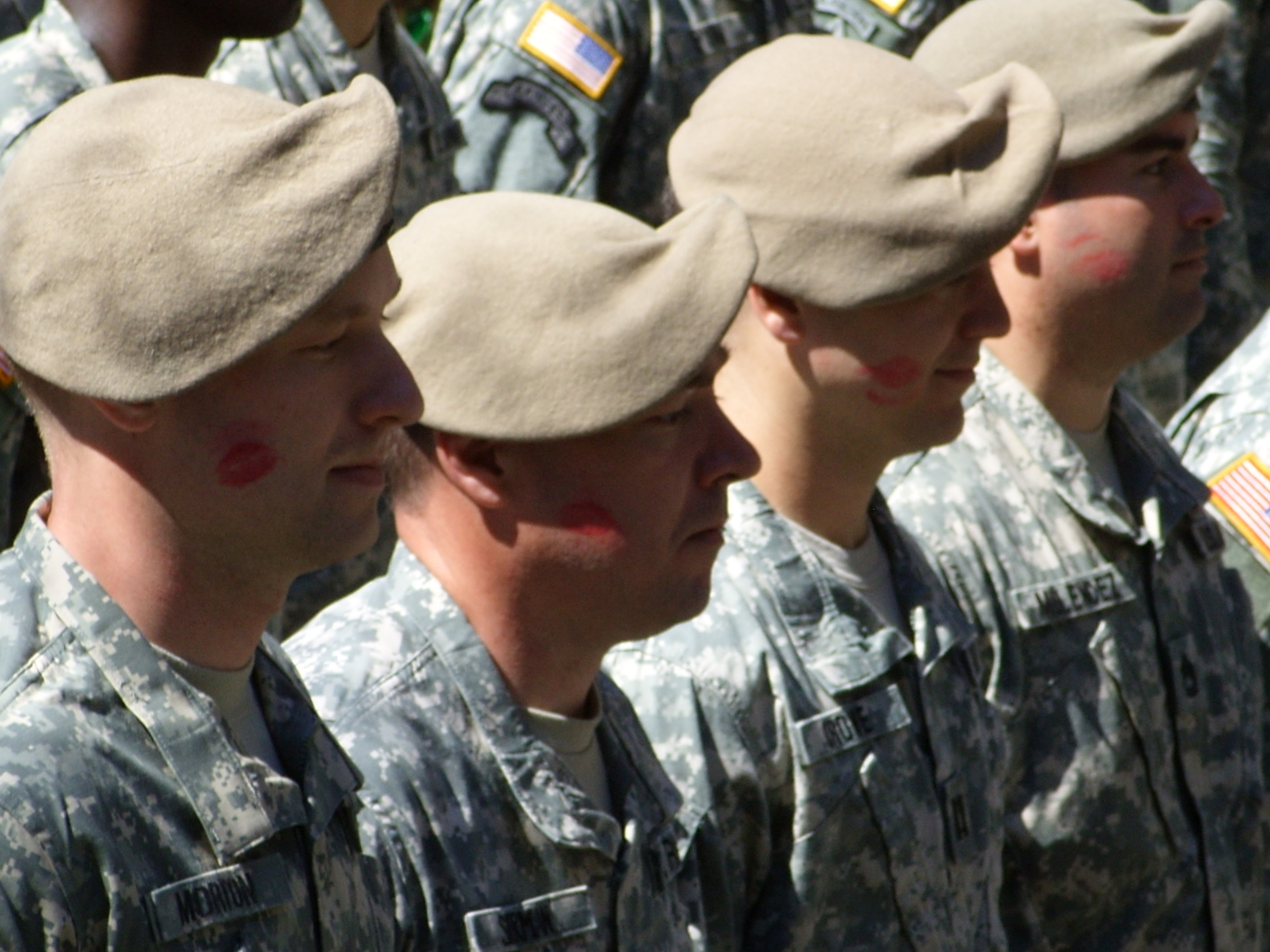  A row of local military, branded by kissing bandits 