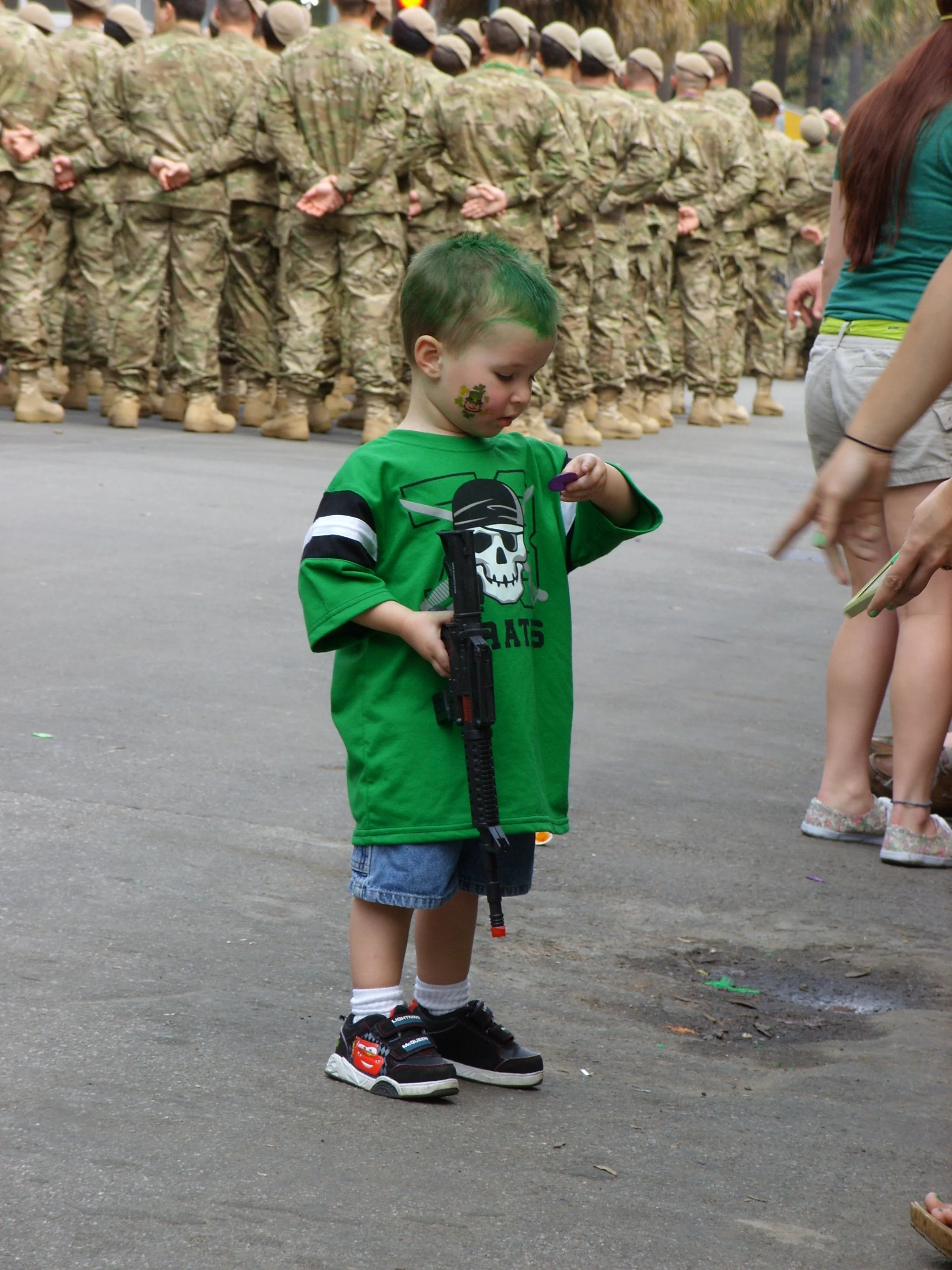  A little guy taking a close look at a token someone in the parade threw to him 