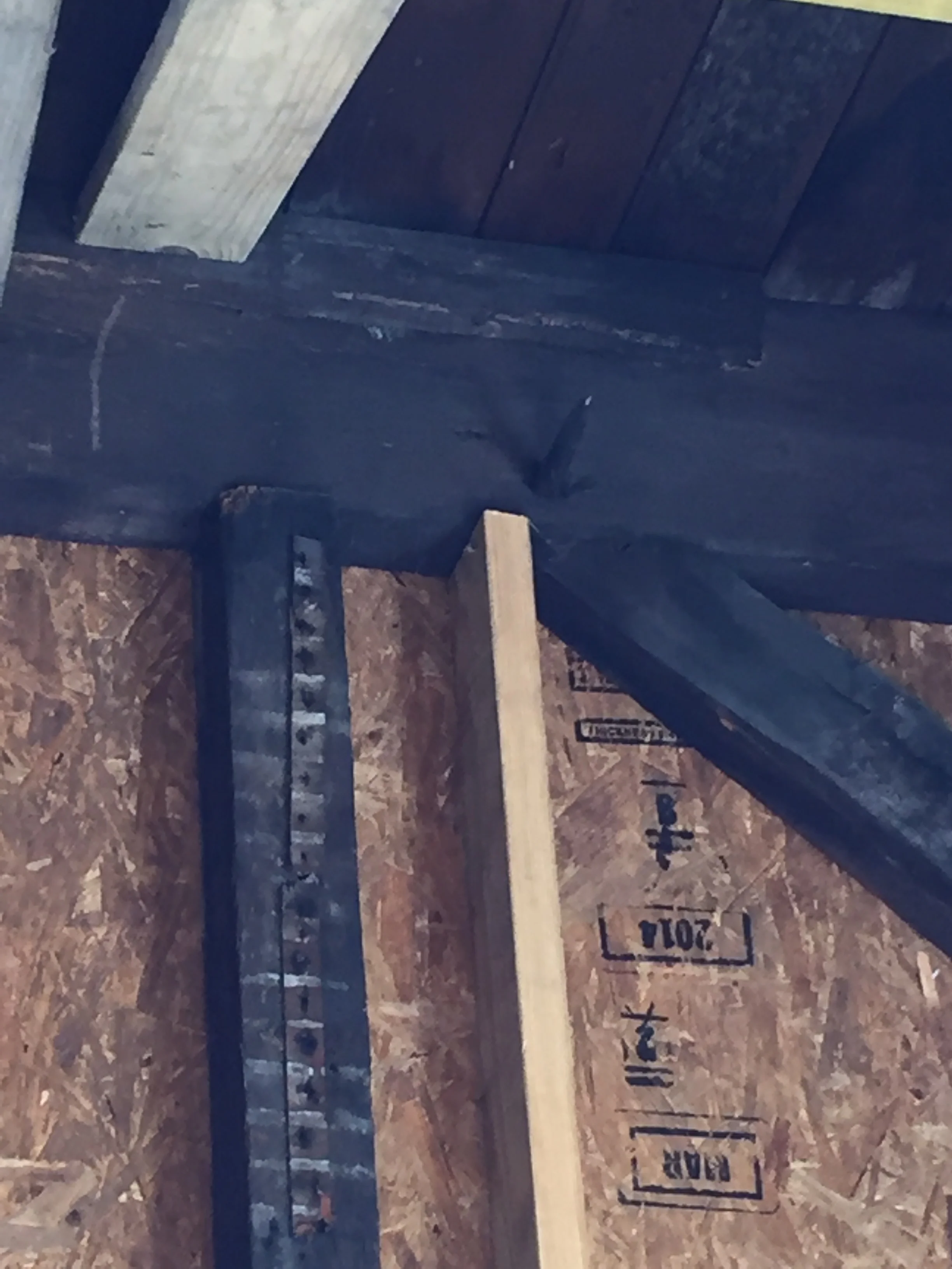Closeup view of old beams notched together and pegged in place.