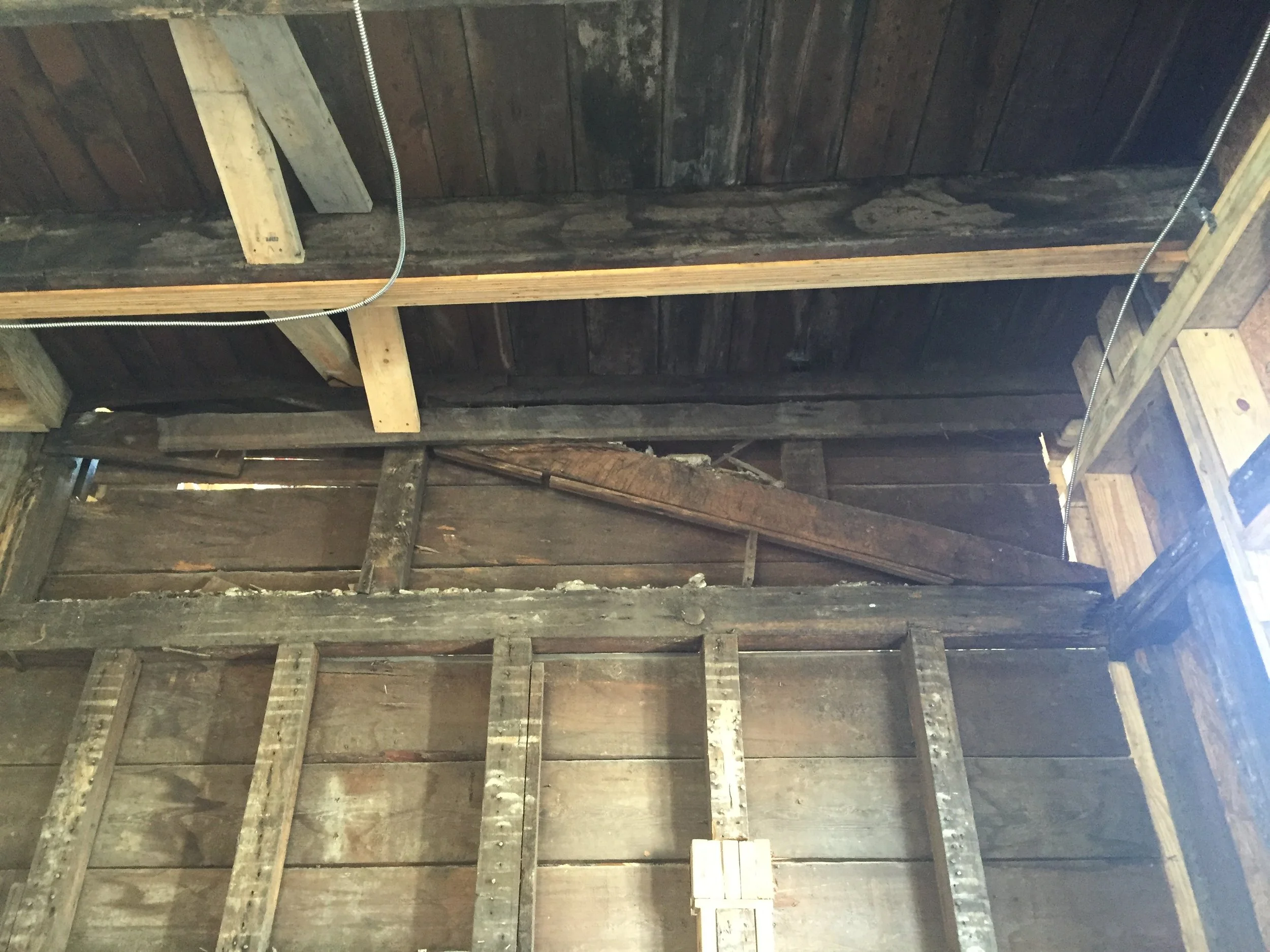 The slanted beam up top is a holdover from the original first story roof line, before the height at the back of the house was extended.