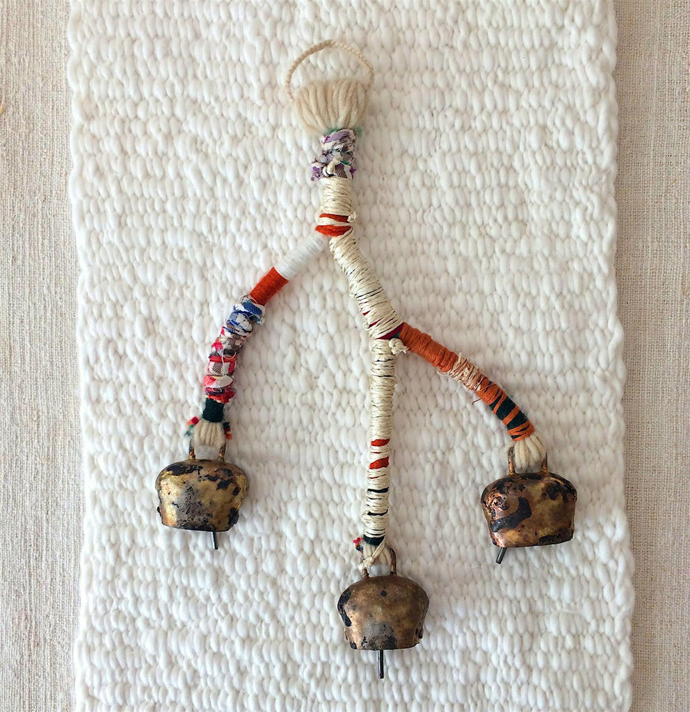 Handmade shepherd’s bells with recycled textiles and fiber | part of the Lost in Fiber artifact library (made by Abigail Doan) and photographed on a VOZ woven panel.