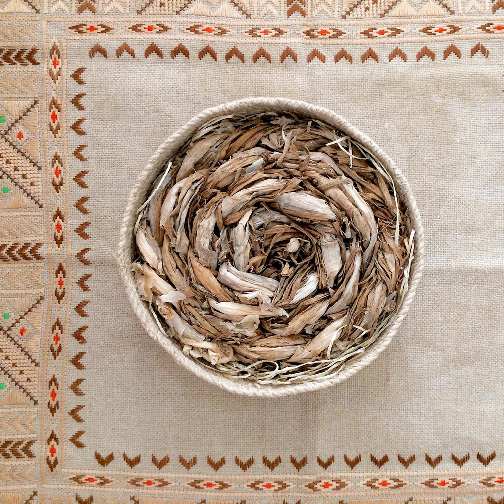 Hand-plaited grasses from rural New Mexico photographed on a traditional Bulgarian embroidery textile. ‘Chaguar’ basket is made by artisans in Argentina for NURAXI .