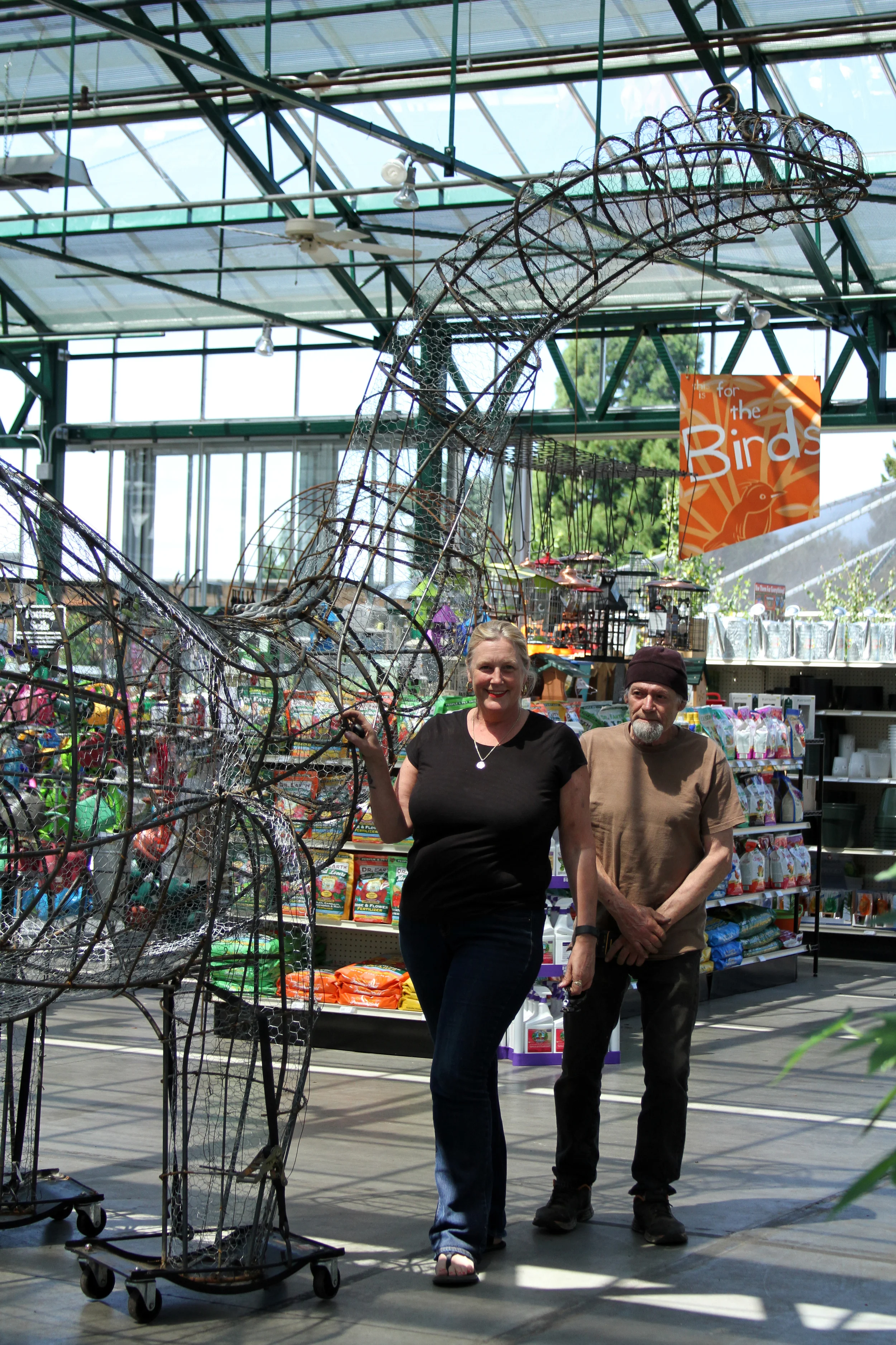 The artist and a member of her assembly team standing near the newly-installed sculpture