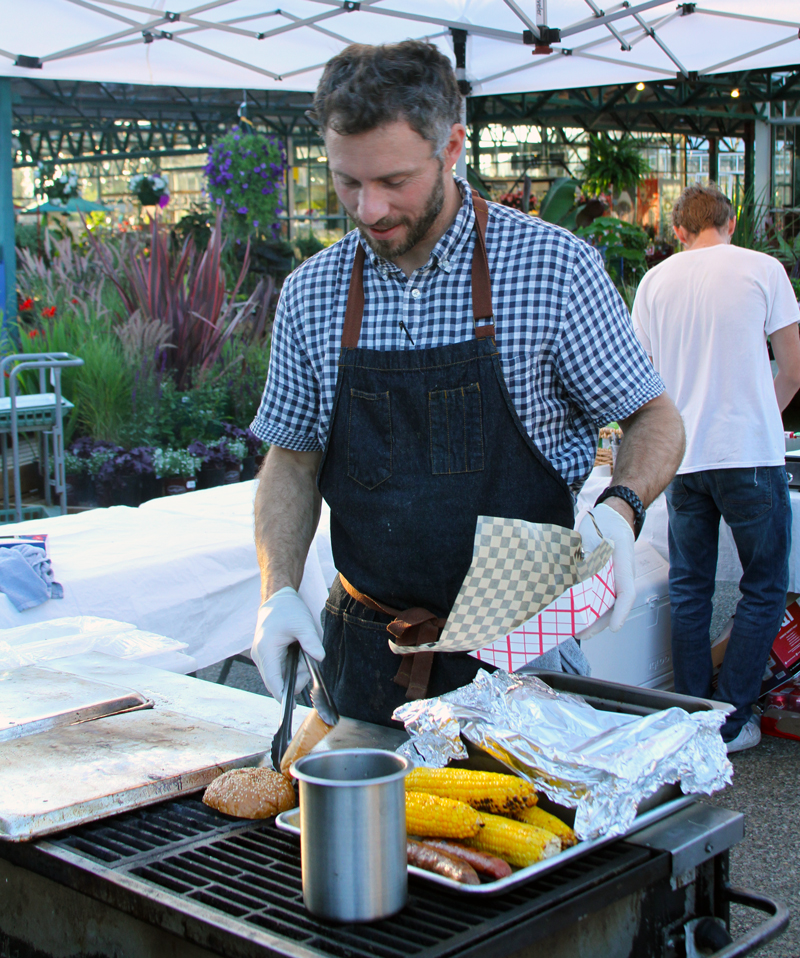Casey, owner of Barn & Field, grilling at Family Night