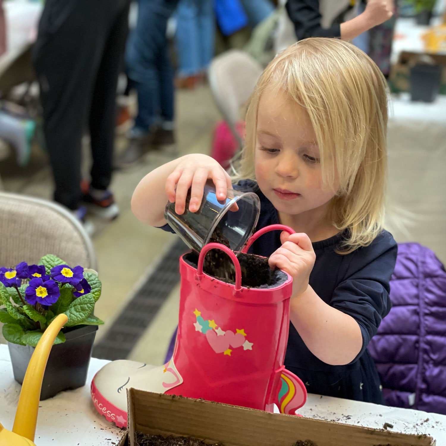 Girl-planting-a-rainboot.jpg