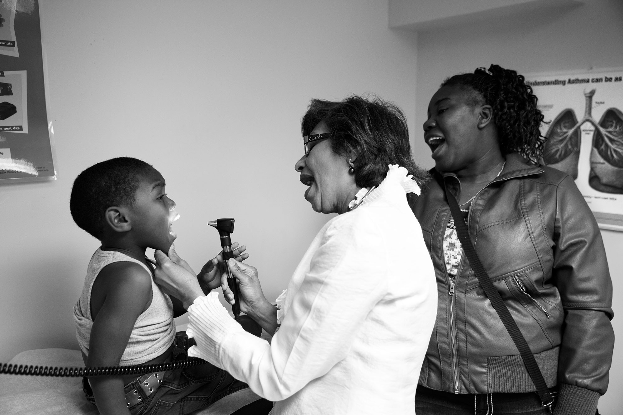 Asthma patient Onilson Avila Dionicio, 4, is examined by Dr. Mohammad while his mother watches.