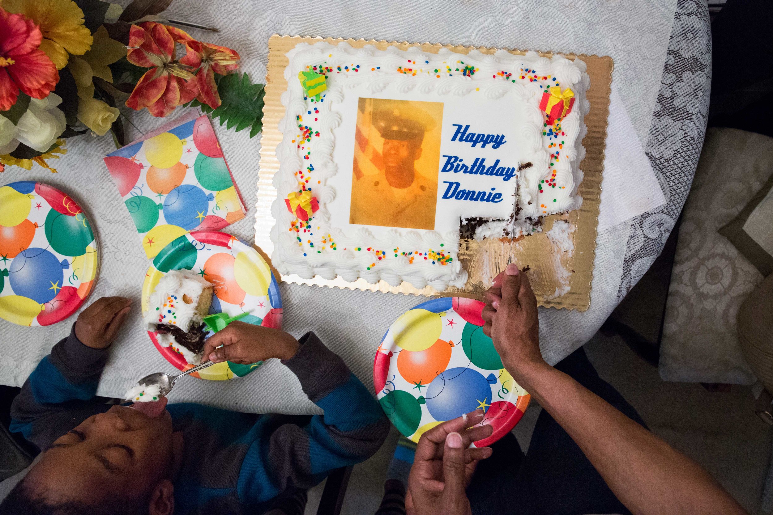 Ronald, also known as “Donnie” to his family, cuts into his 59th birthday cake with his great-nephew on his left, on January 10, 2016. This birthday marked his first birthday out of prison; the last birthday he remembers as a free man, he was the ag