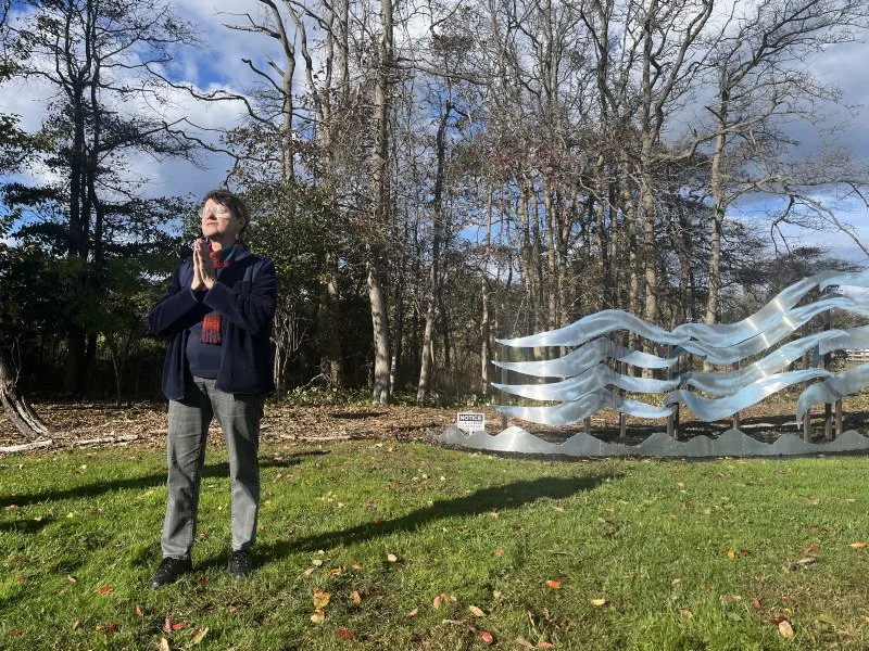   Dorsey Lucas with her sculpture, Rising Waters  
