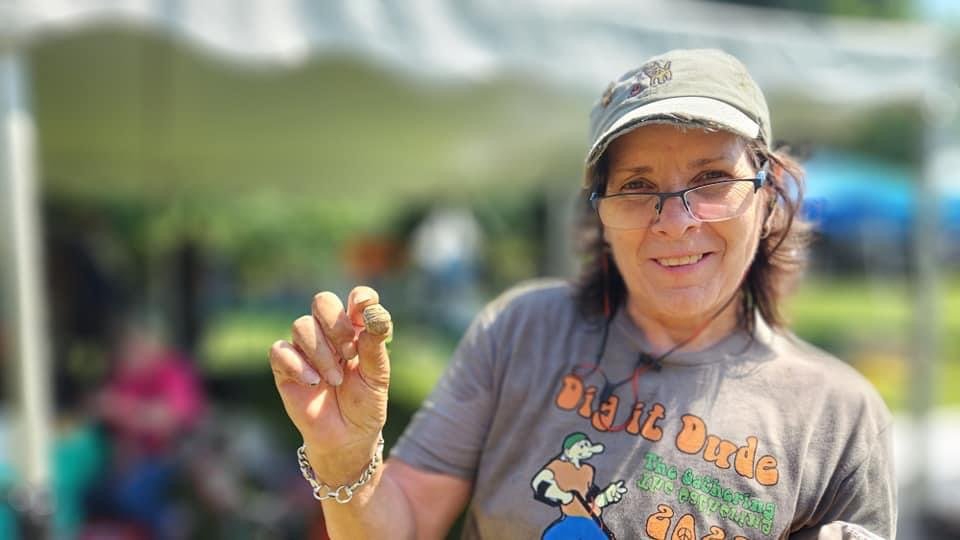 Janice Lind with her find, a Civil War 3-ring bullet or " 3-ringer"
