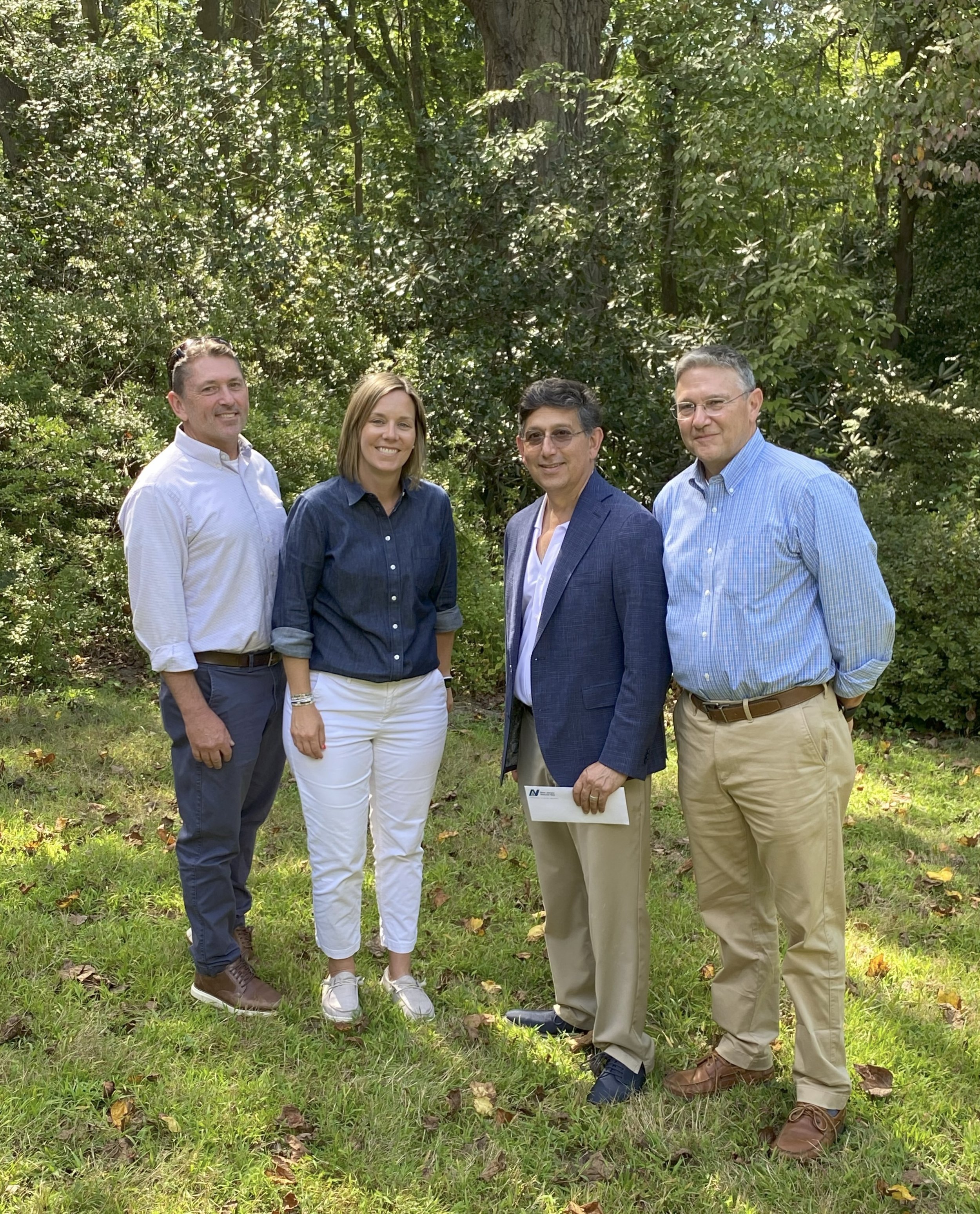 Ray Bukowski, NJR's Managing Director of Government Affairs, Communications, and Sustainability, and Katie Feery, NJR's Director of Strategic Initiatives and Sustainability, celebrate the next installment of the Scudder grant distribution with MCF president Matt Cohen and Marty McHugh, chair of the Scudder Preserve Committee. Photo by Bill Kastning.